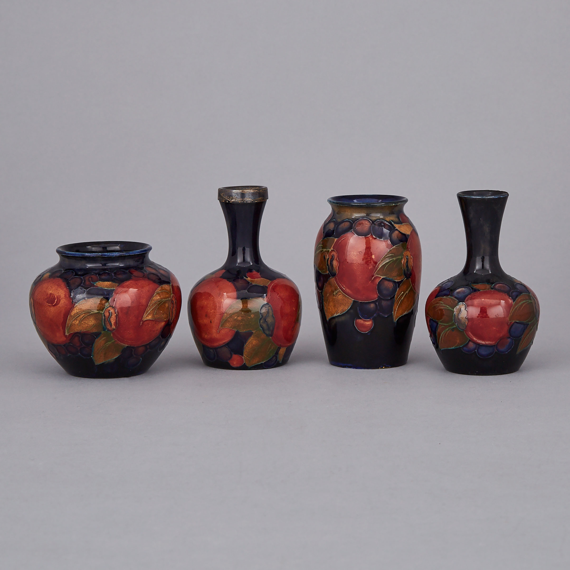 Four Moorcroft Miniature Pomegranate Vases, c.1920-25