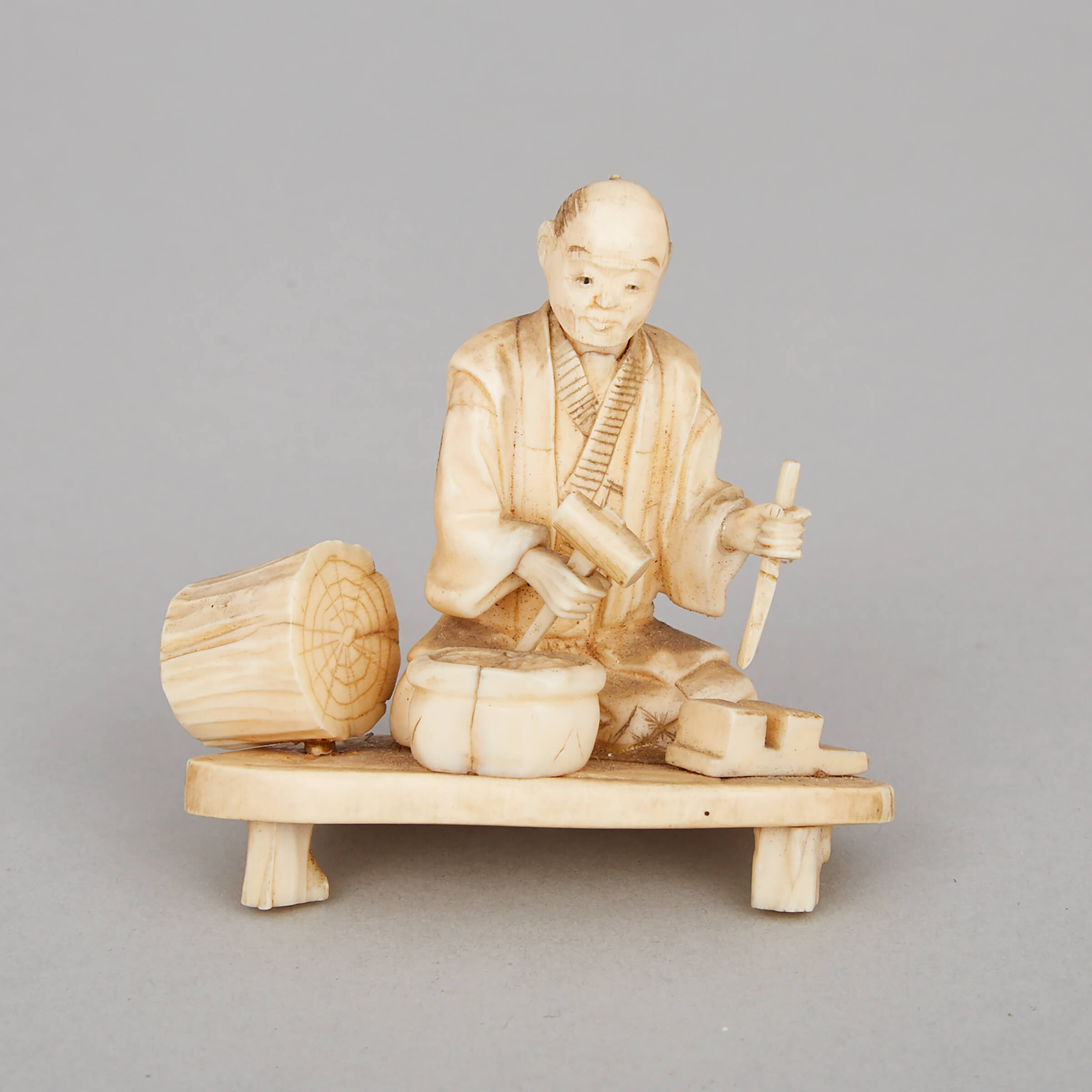 An Ivory Okimono of a Worker, Meiji Period