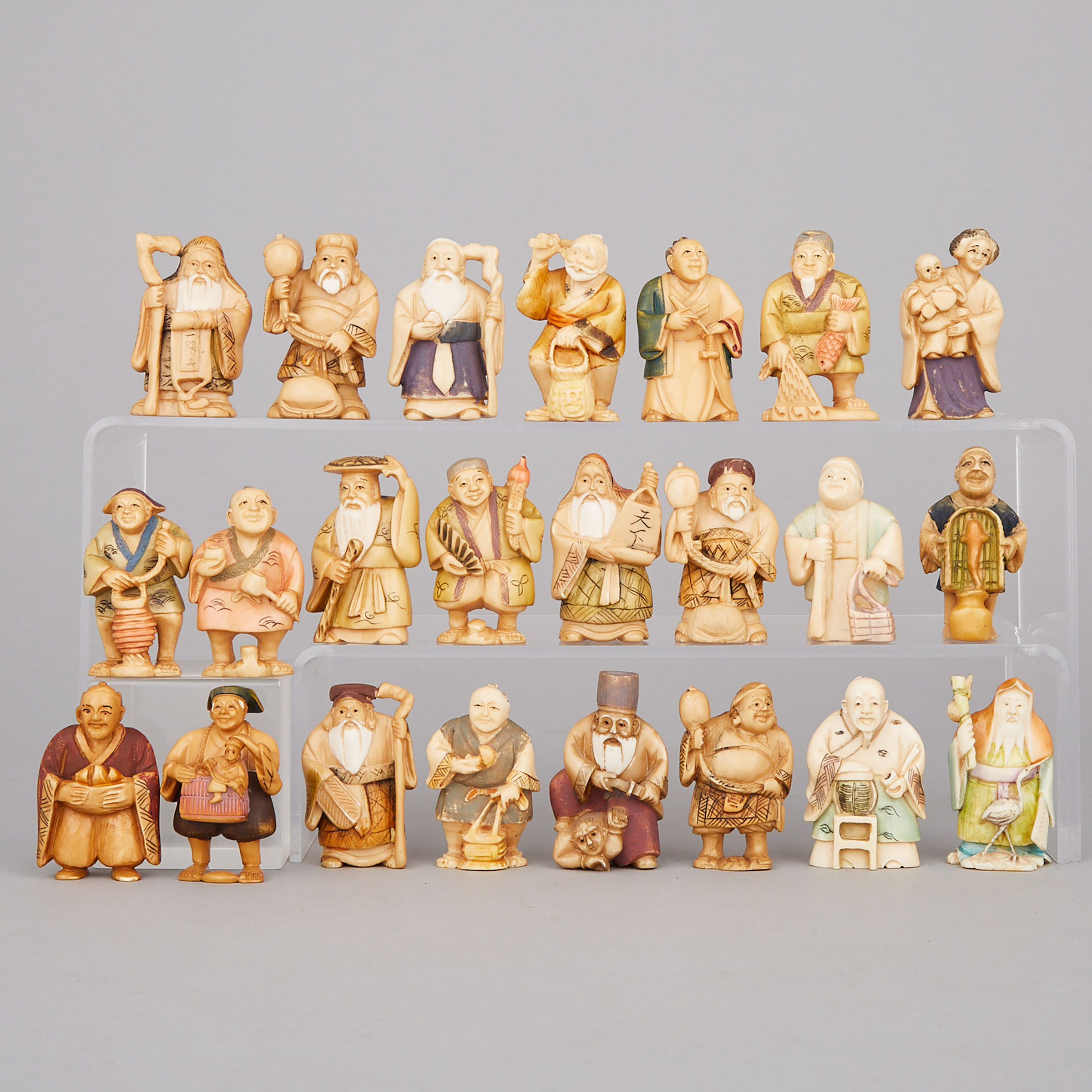A Group of Twenty-Three Polychrome Ivory Figures