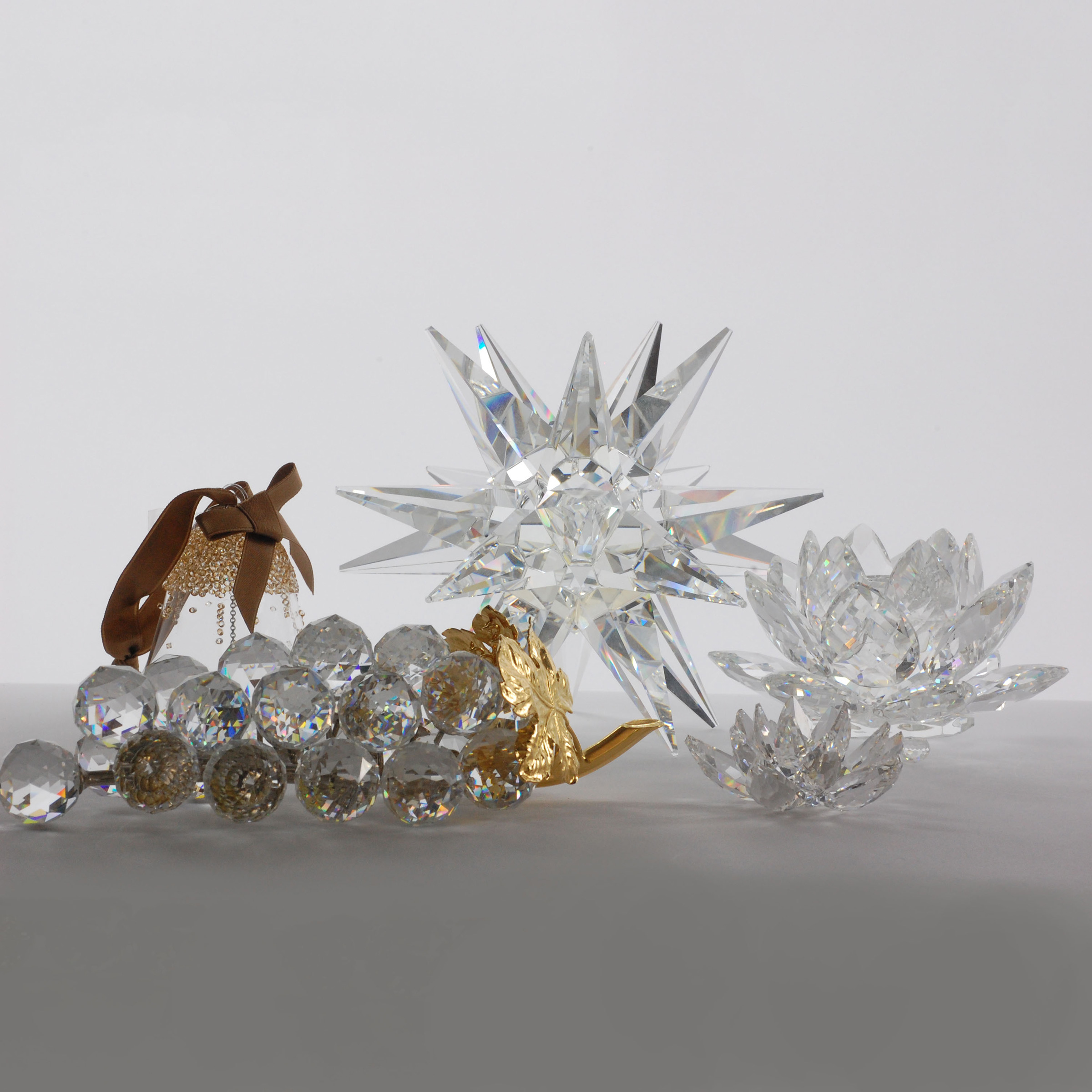 Three Swarovski Crystal Candleholders and Two Sculptures, late 20th/early 21st century