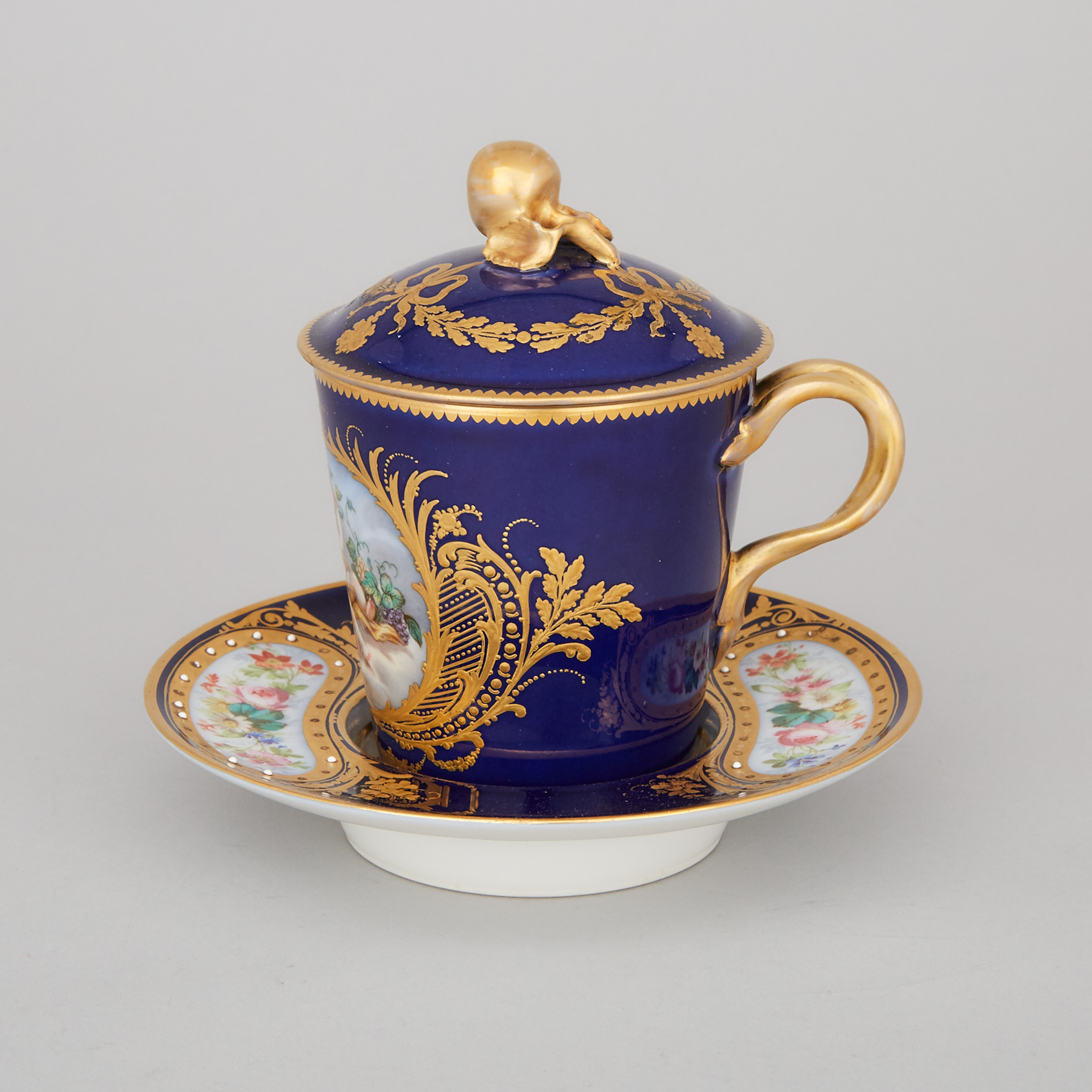 'Sèvres' 'Jeweled' Blue Ground Covered Cup and Saucer, early 20th century