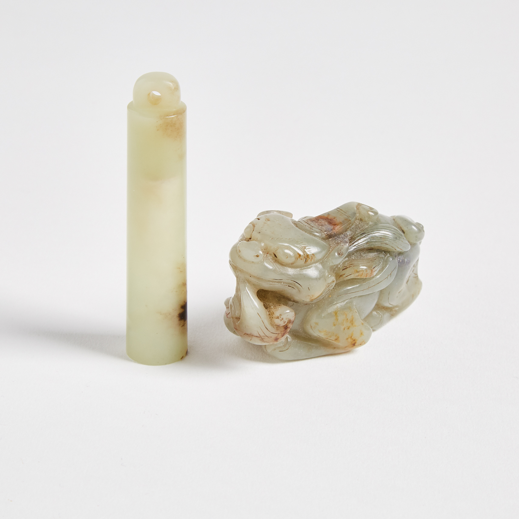 A Celadon and Russet Jade Official's Hat Tube and a Carved Beast