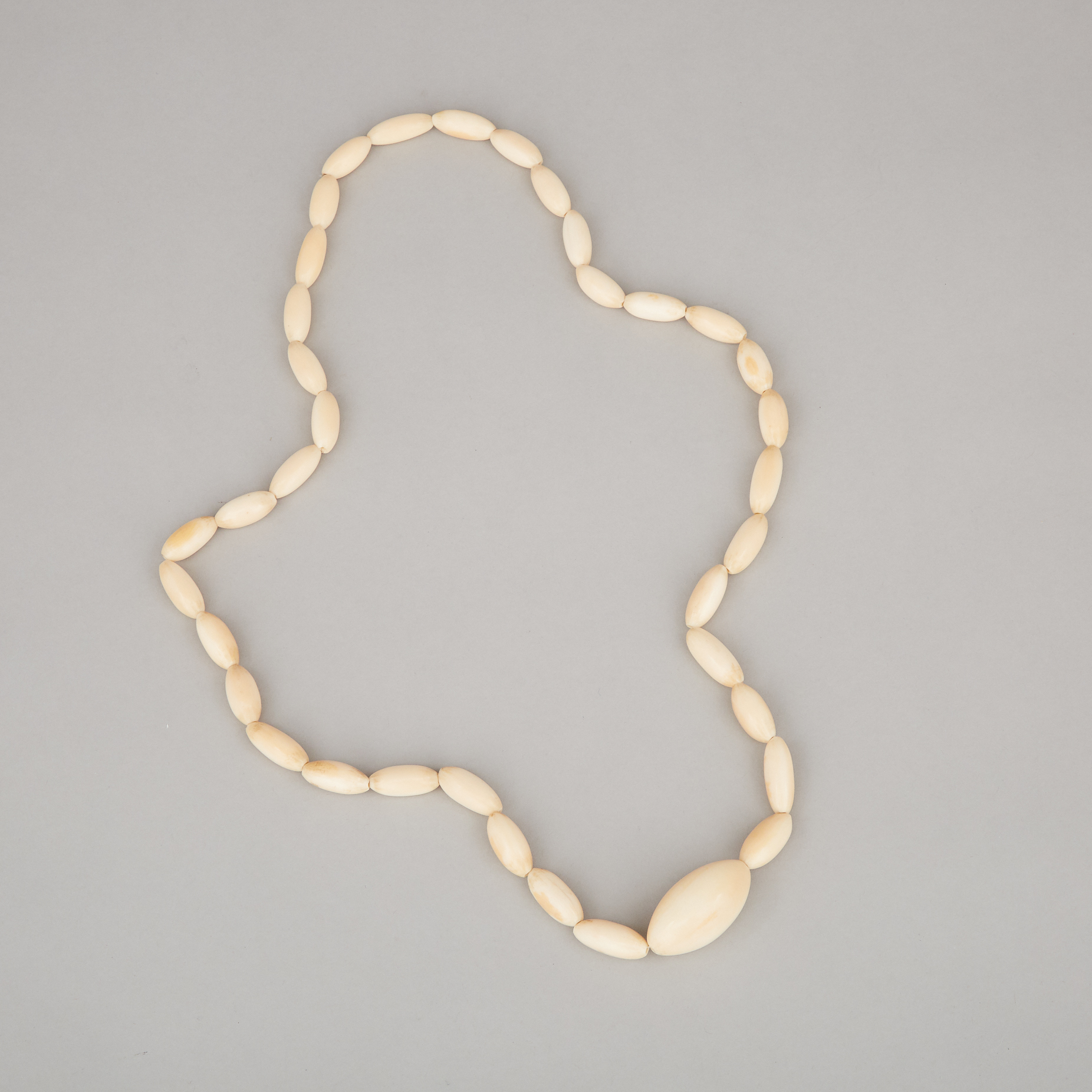 An Ivory Carved Oval Bead Necklace, Mid-20th Century