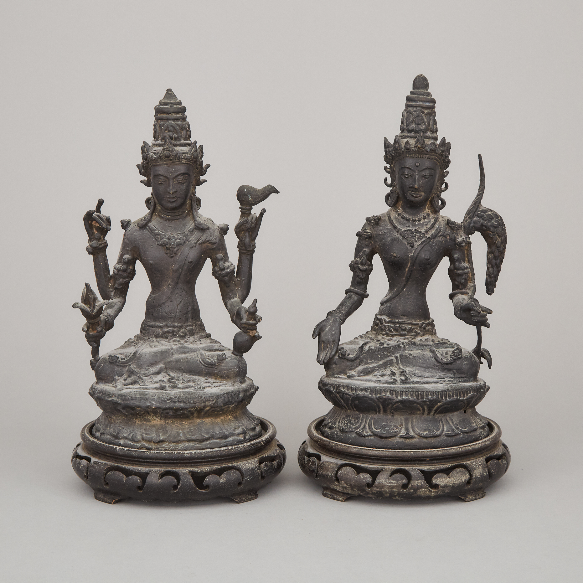 Two Indonesian Bronze Seated Figures of Vishnu and Dewi Sri
