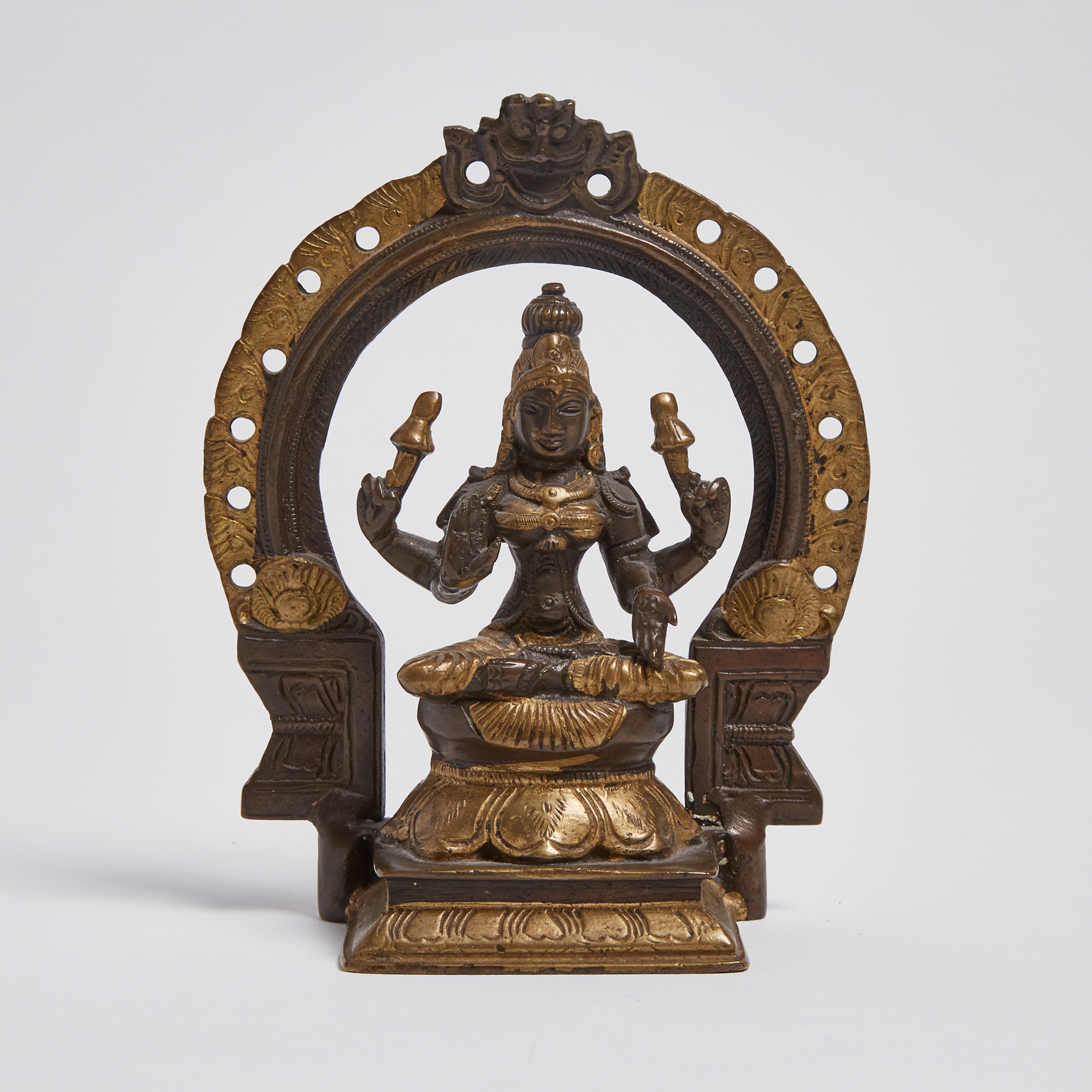 A Parcel-Gilt Bronze Seated Figure of a Female Deity, South India