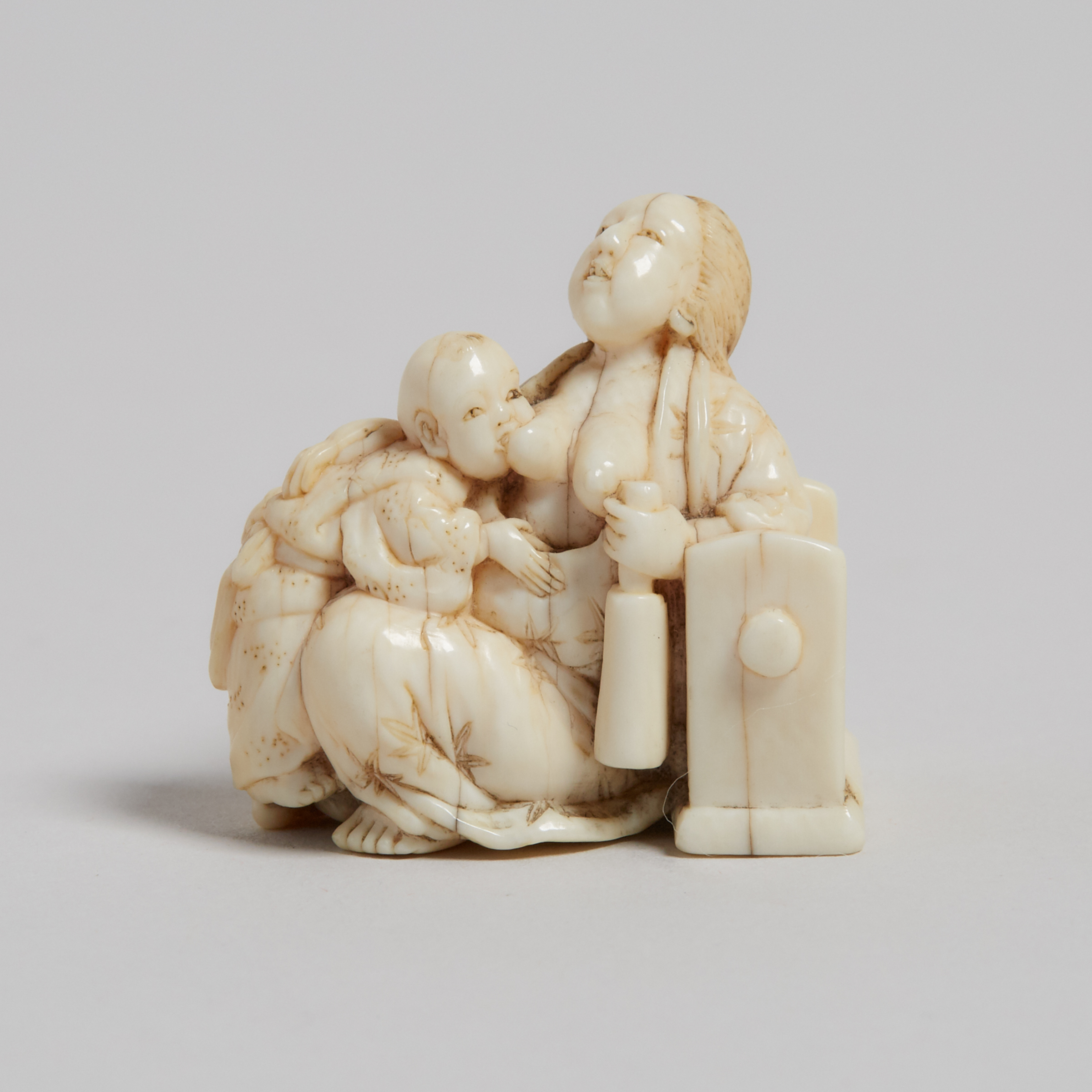 An Ivory Carved Netsuke of a Mother and Child, 19th Century