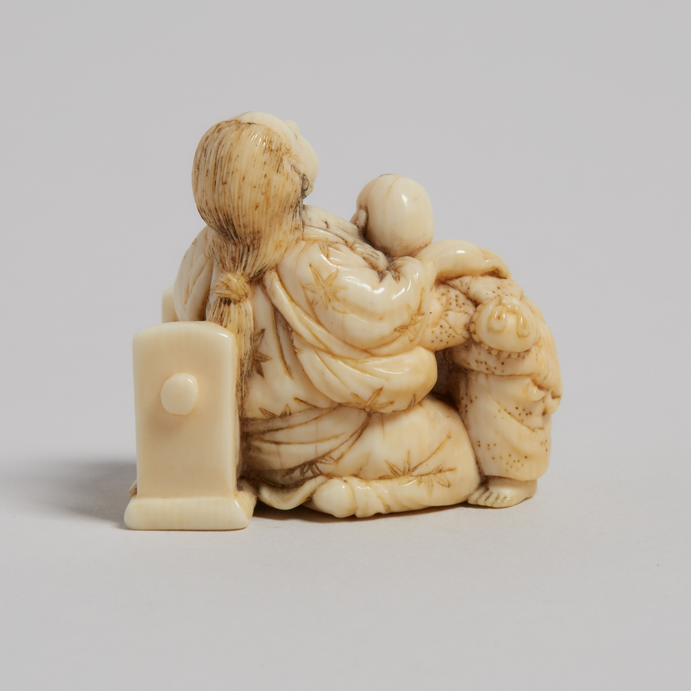 An Ivory Carved Netsuke of a Mother and Child, 19th Century