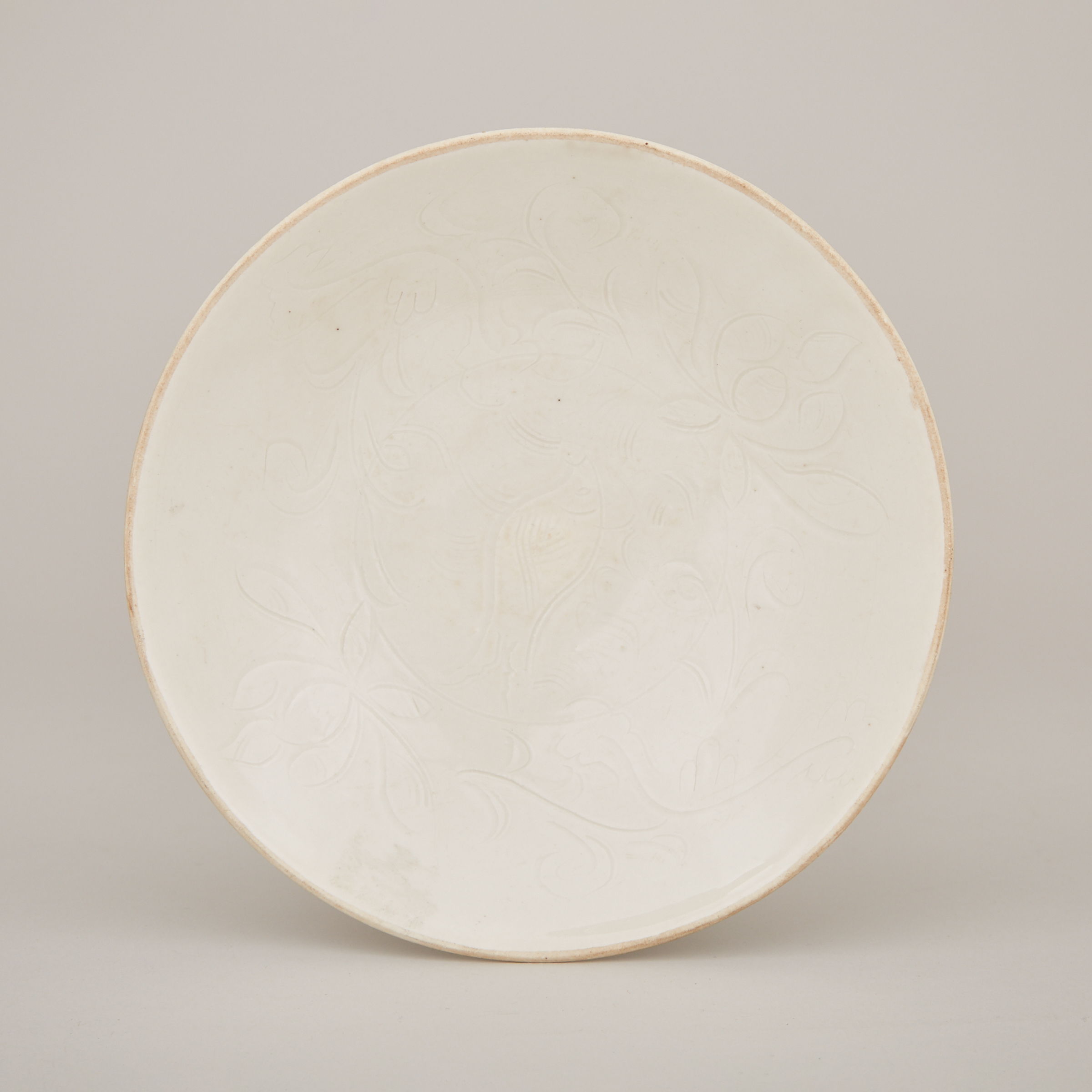 A Carved Ding 'Fish and Lotus' Dish, Northern Song Dynasty