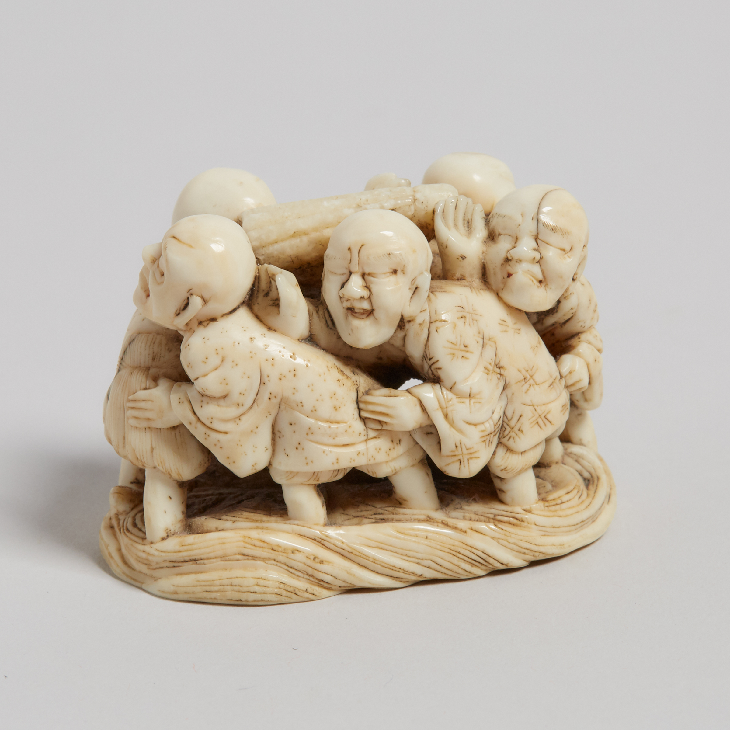 An Ivory Carved 'Blind Men' Group Netsuke, Meiji Period