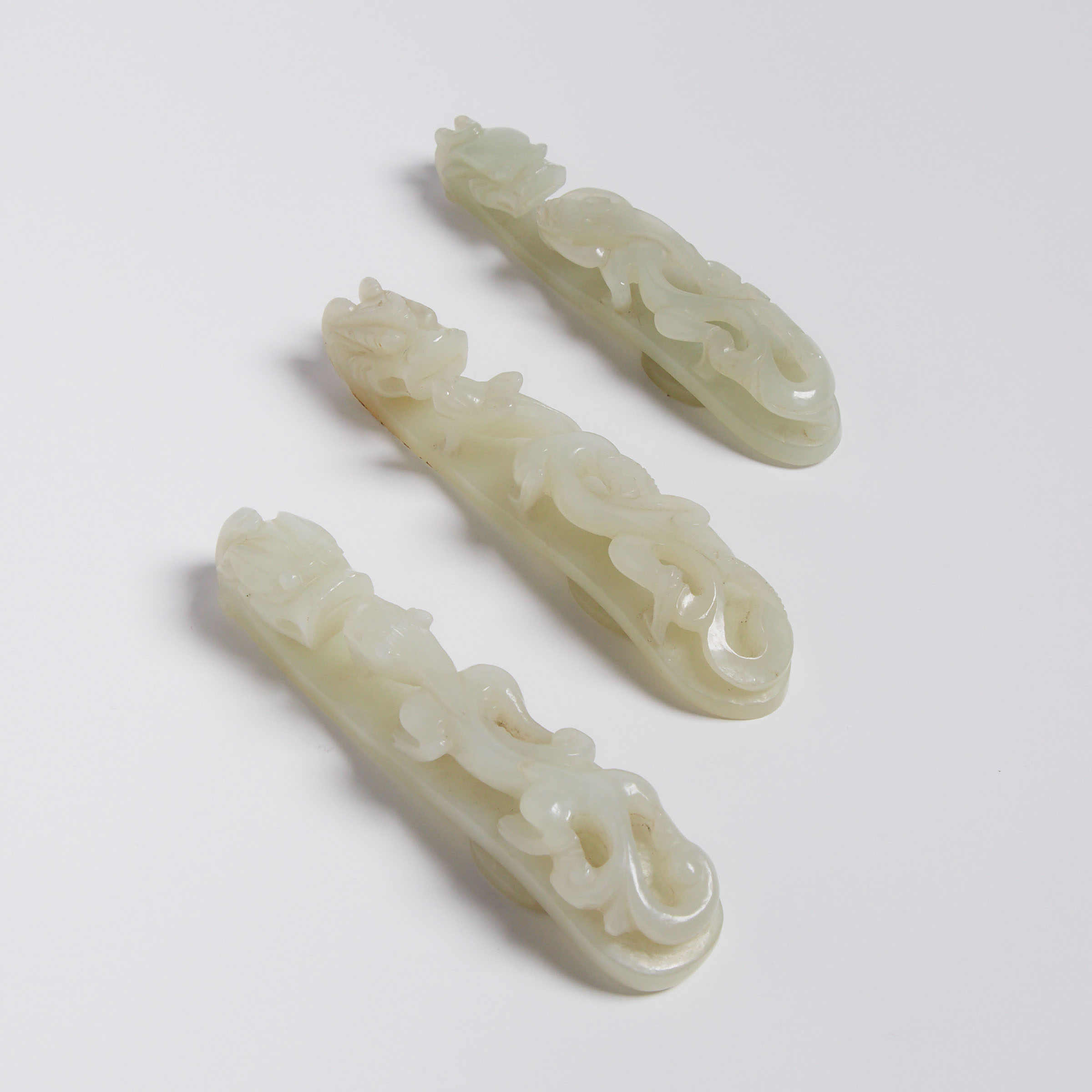 A Group of Three Celadon White Jade Chilong Belt Hooks
