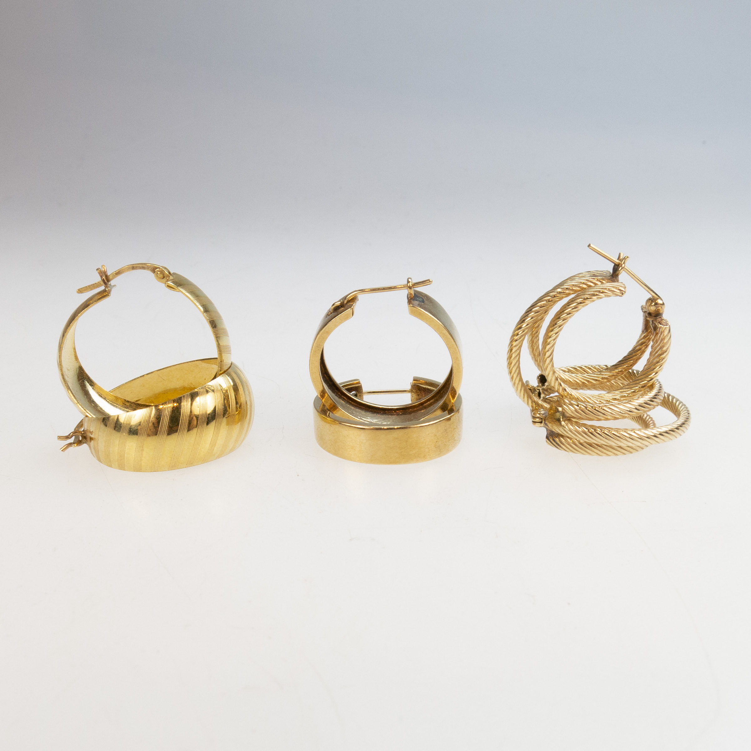 1 x 10k, 1 x 14k and 1 x 18k Pairs Of Yellow Gold Hoop Earrings