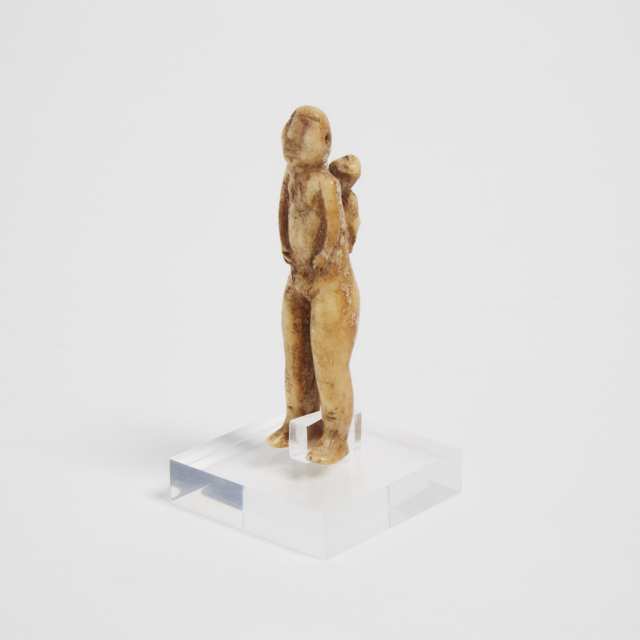 An Archaic Carved Ivory Amulet Figure of a Mother and Child, Cape Wales Village, Alaska