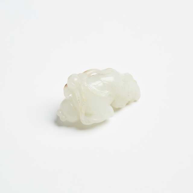 A White Jade and Russet Boy Holding Lotus Branch, Late Qing Dynasty