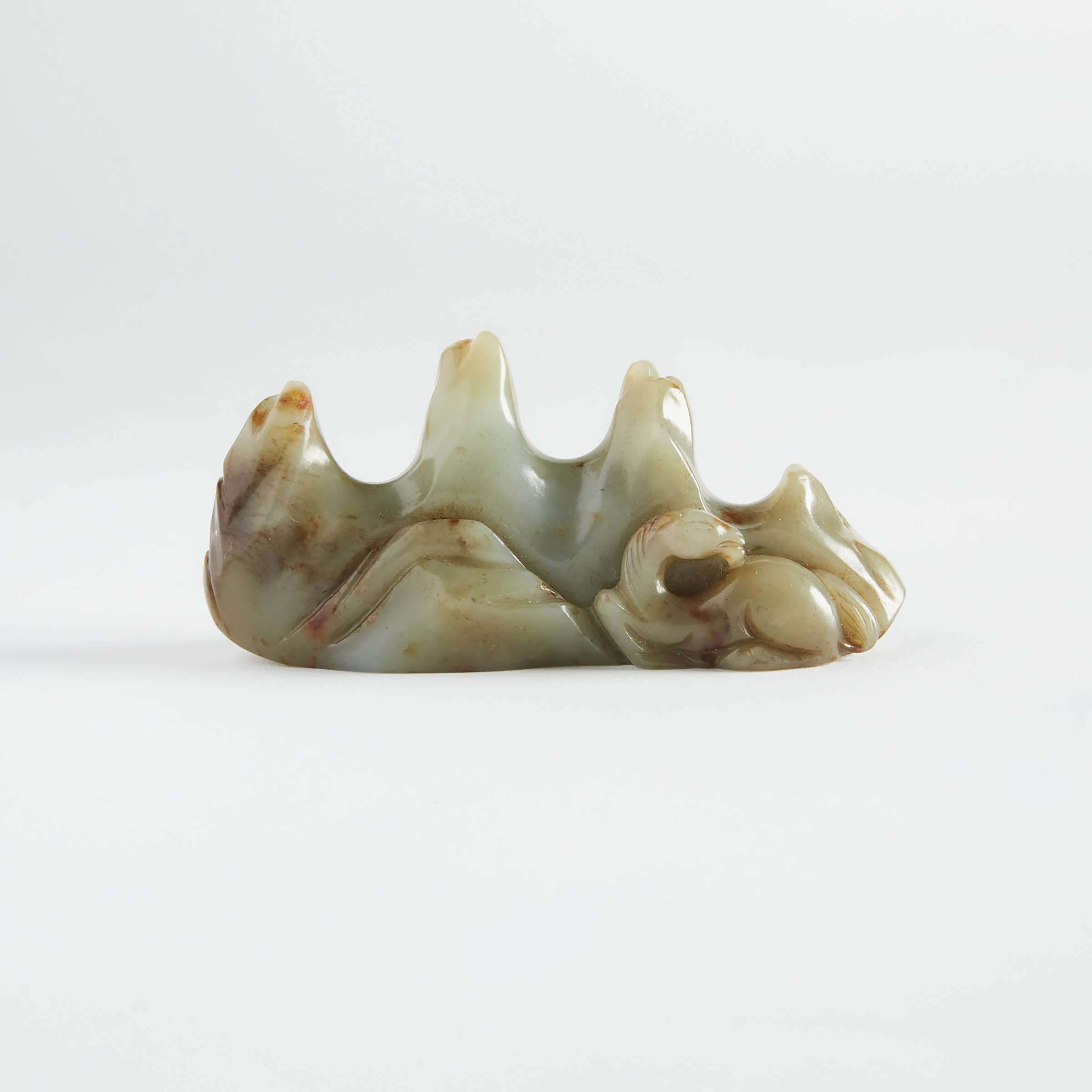 A Celadon and Russet Jade 'Mountain' Brushrest, Early 20th Century