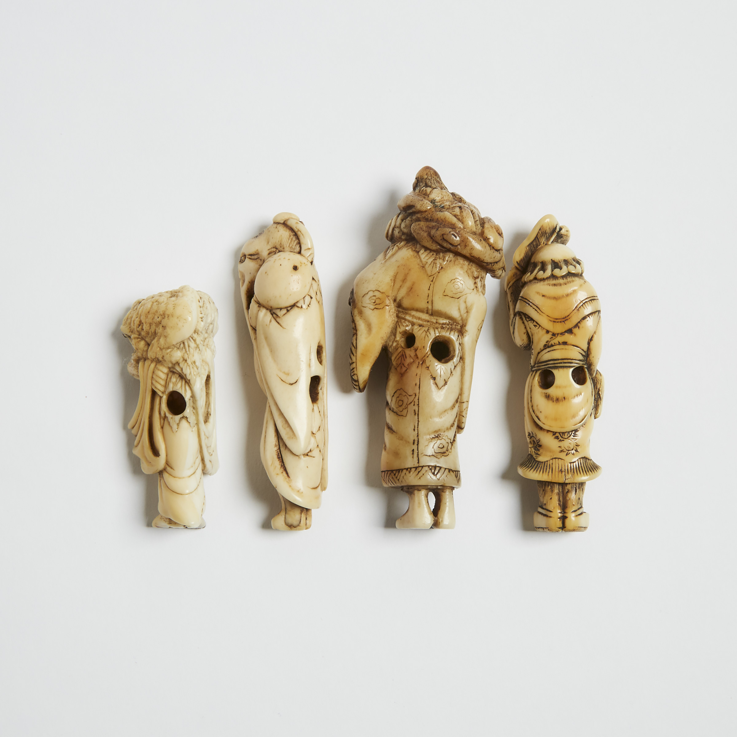 A Group of Four Ivory and Horn Netsuke of Standing Figures, 18th/19th Century