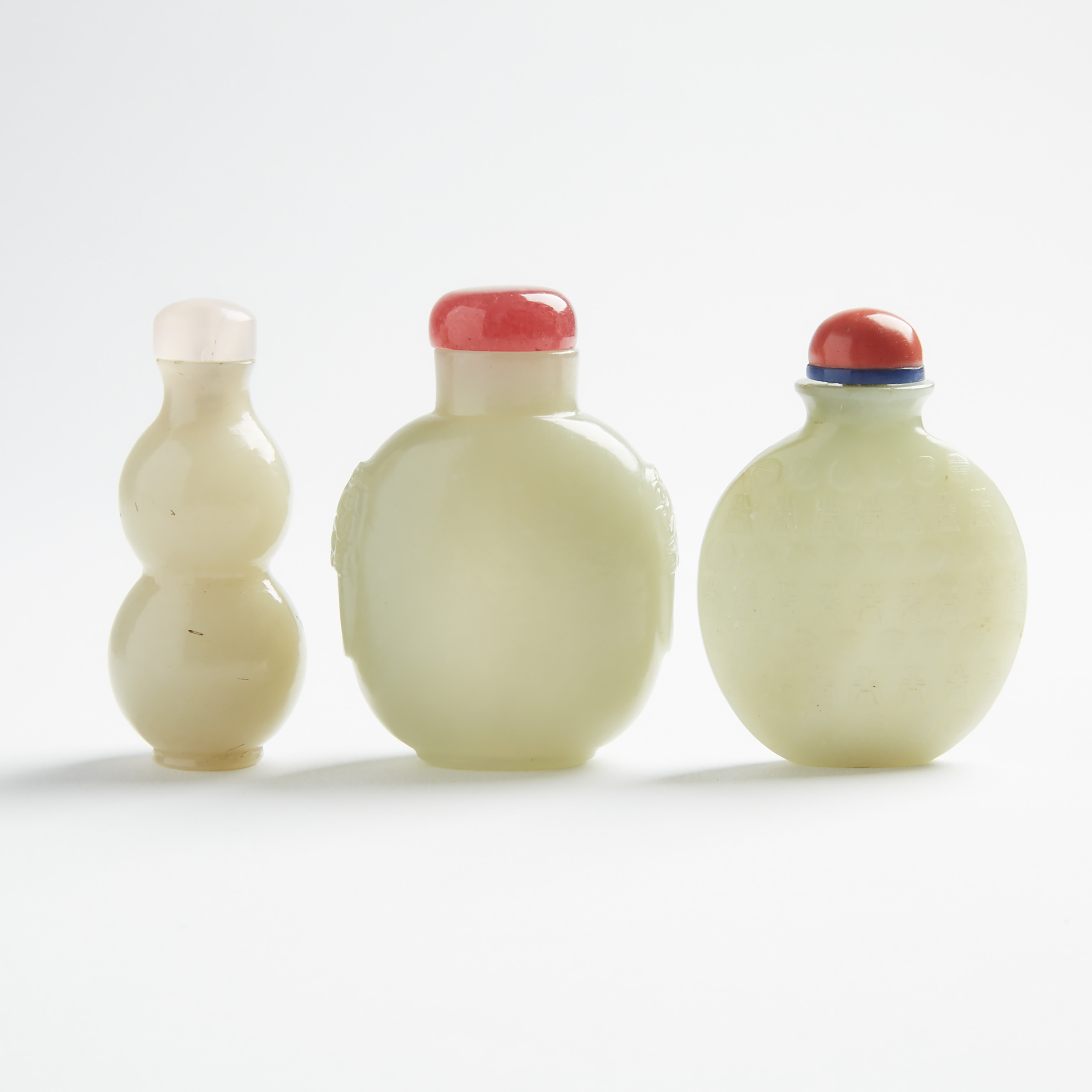 A Group of Three Jade Snuff Bottles, 19th Century/20th Century