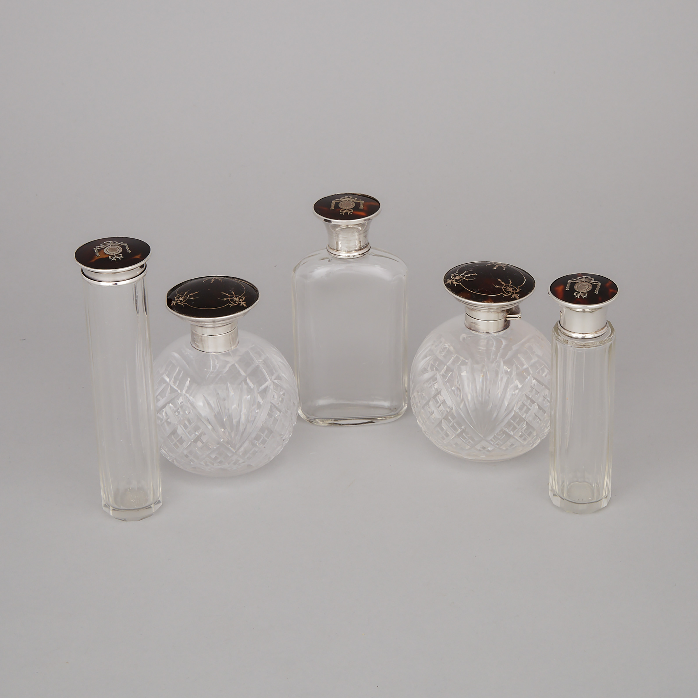 Five English Silver and Tortoiseshell Mounted Cut Glass Toilet Water Bottles and Jars, 1920s