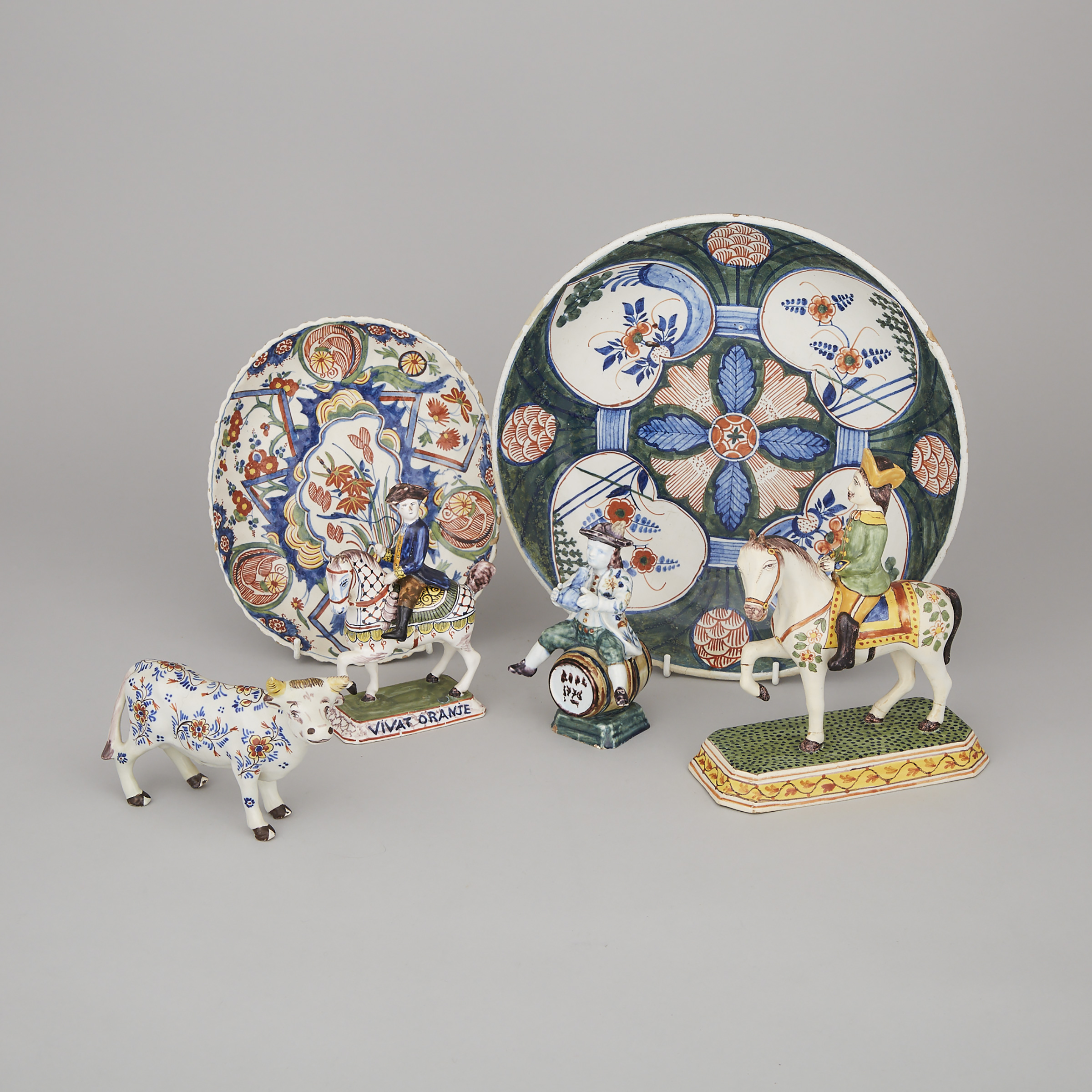 Two Delft Polychrome Dishes, Two Figures on Horseback, Model of a Bull and a Figure Seated Astride a Barrel, 18th/19th century
