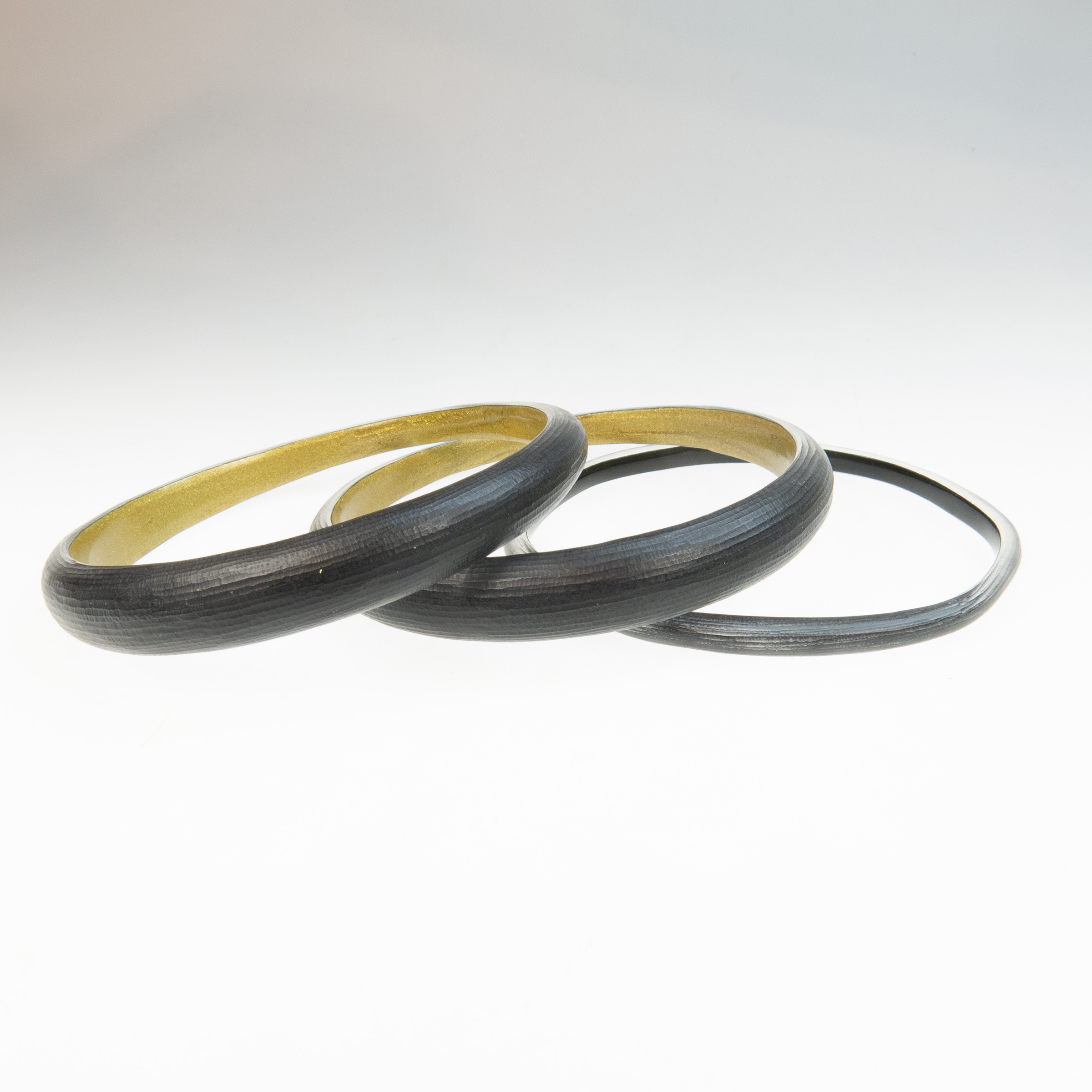 Three Alexis Bittar Carved Black Lucite Bangles 