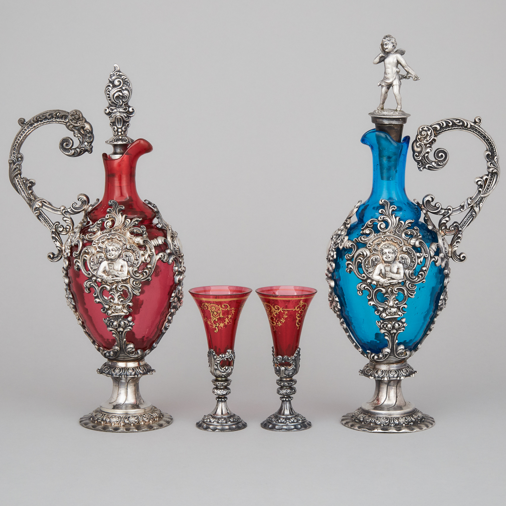 Two German WMF Silver Plated and Coloured Glass Carafes and Two Glasses, c.1900