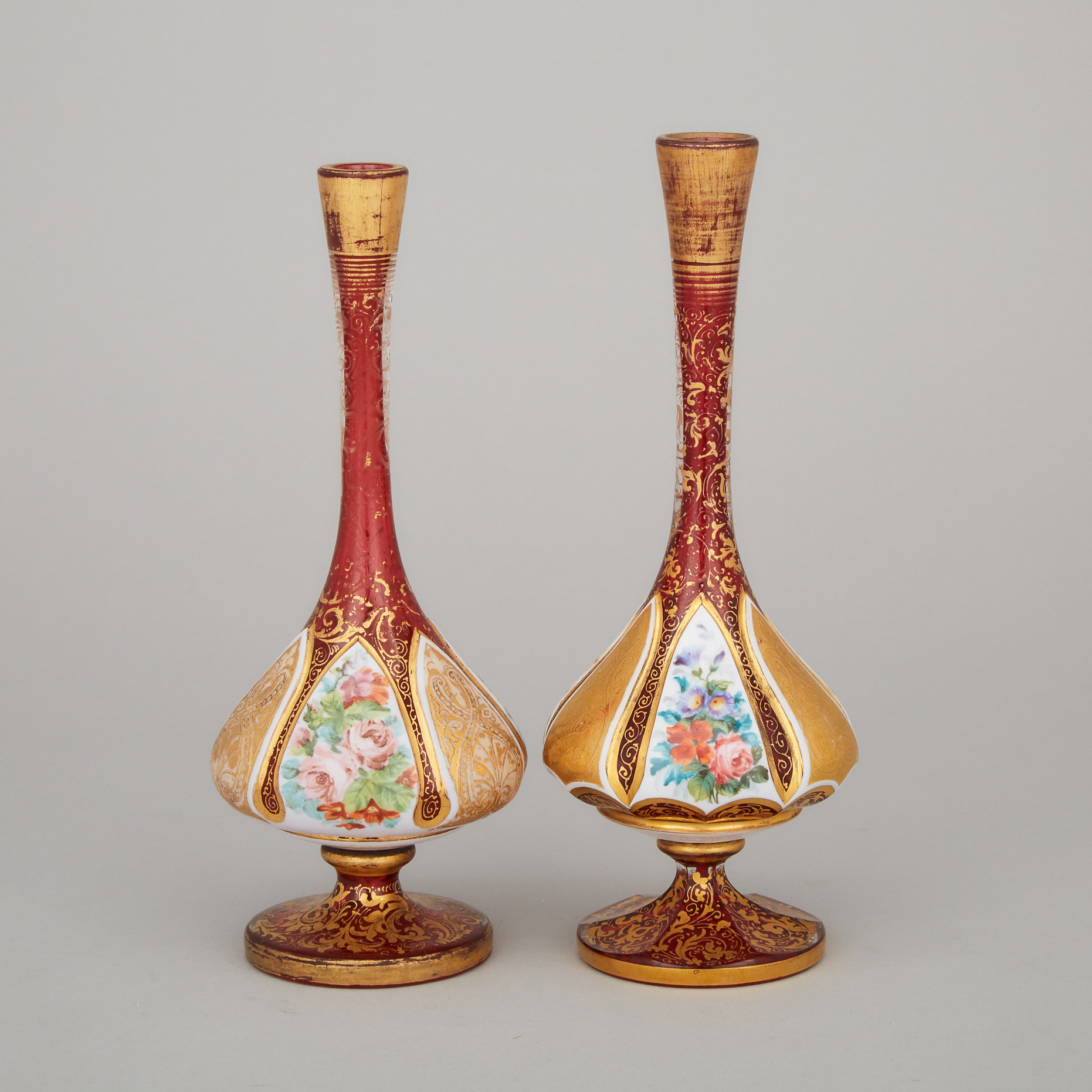 Two Bohemian Overlaid, Enameled, and Gilt Red Glass Vases, late 19th century