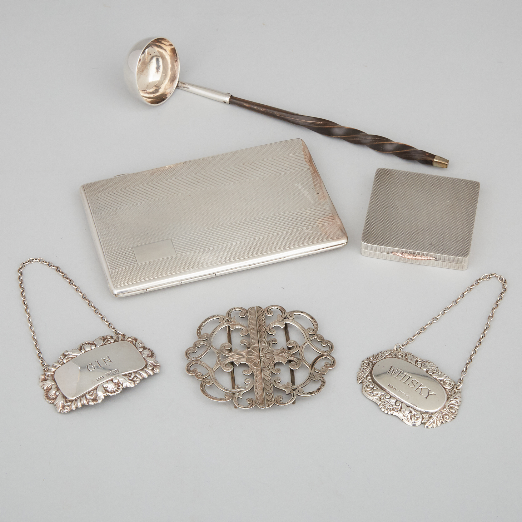 English Silver Cigarette Case, Compact, Belt Buckle, Two Decanter Labels and a Cream Ladle, 19th/20th century