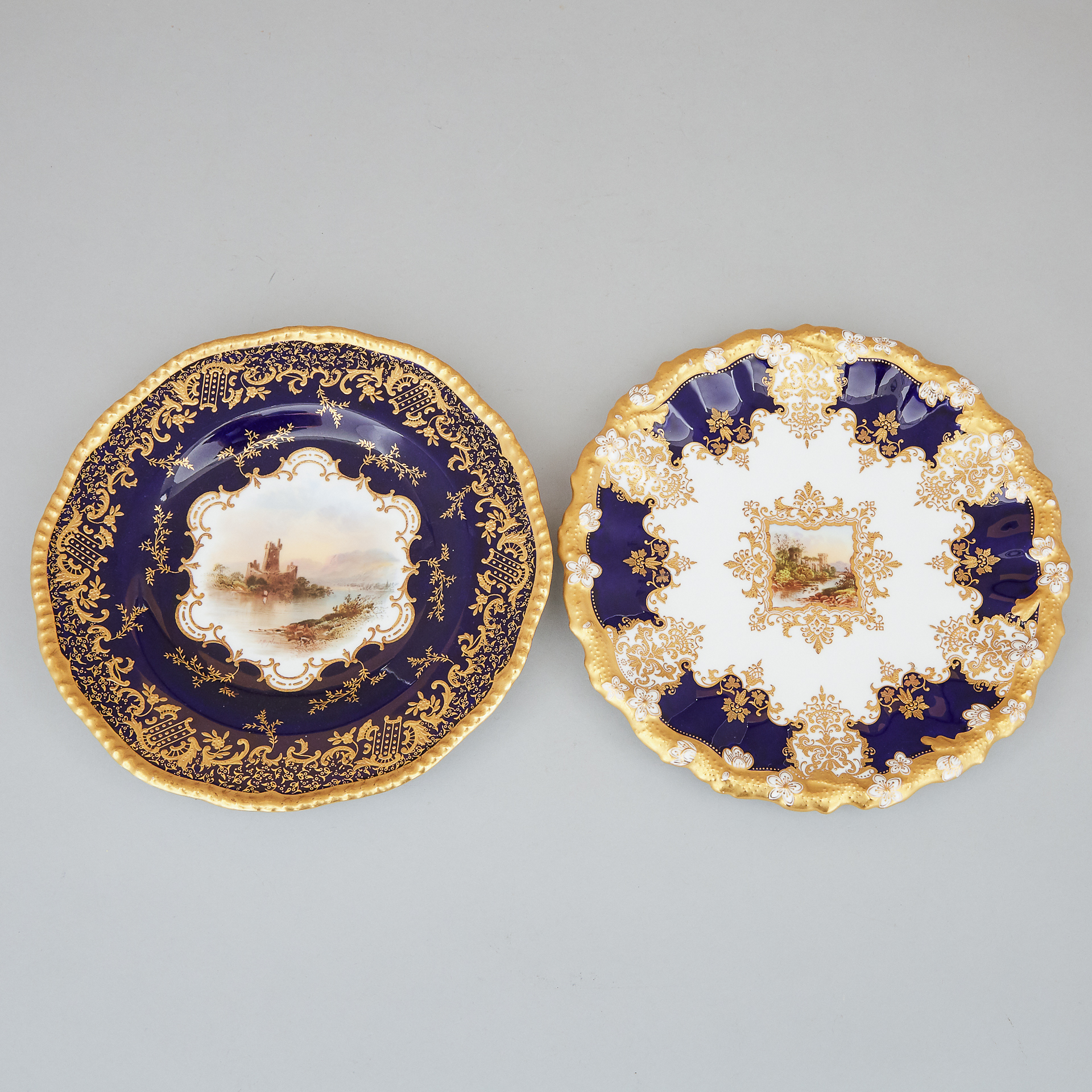 Two Coalport Blue and Gilt Topographical Plates, early 20th century
