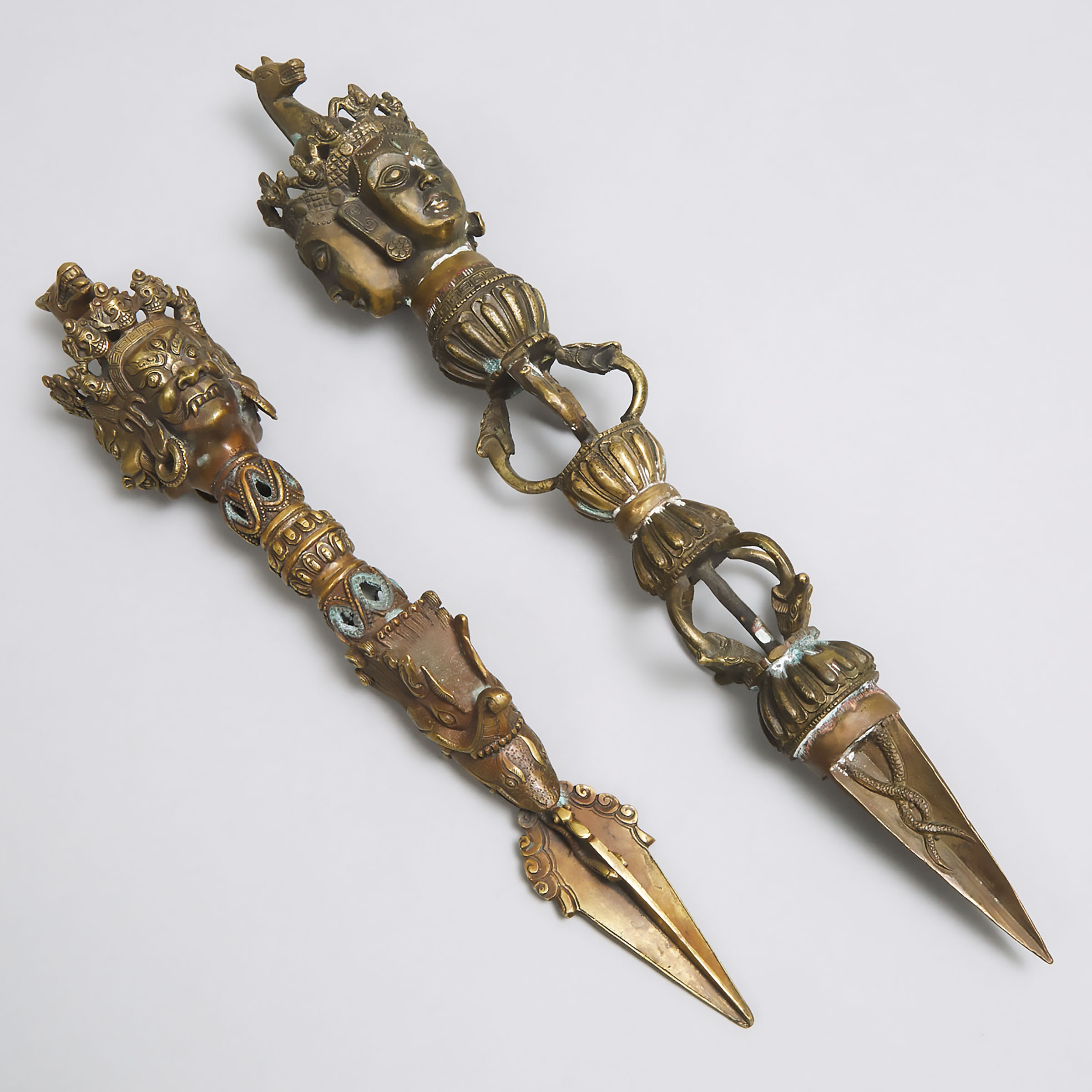 Two Indo-Tibetan Bronze Ceremonial Phurba Daggers, early 20th century