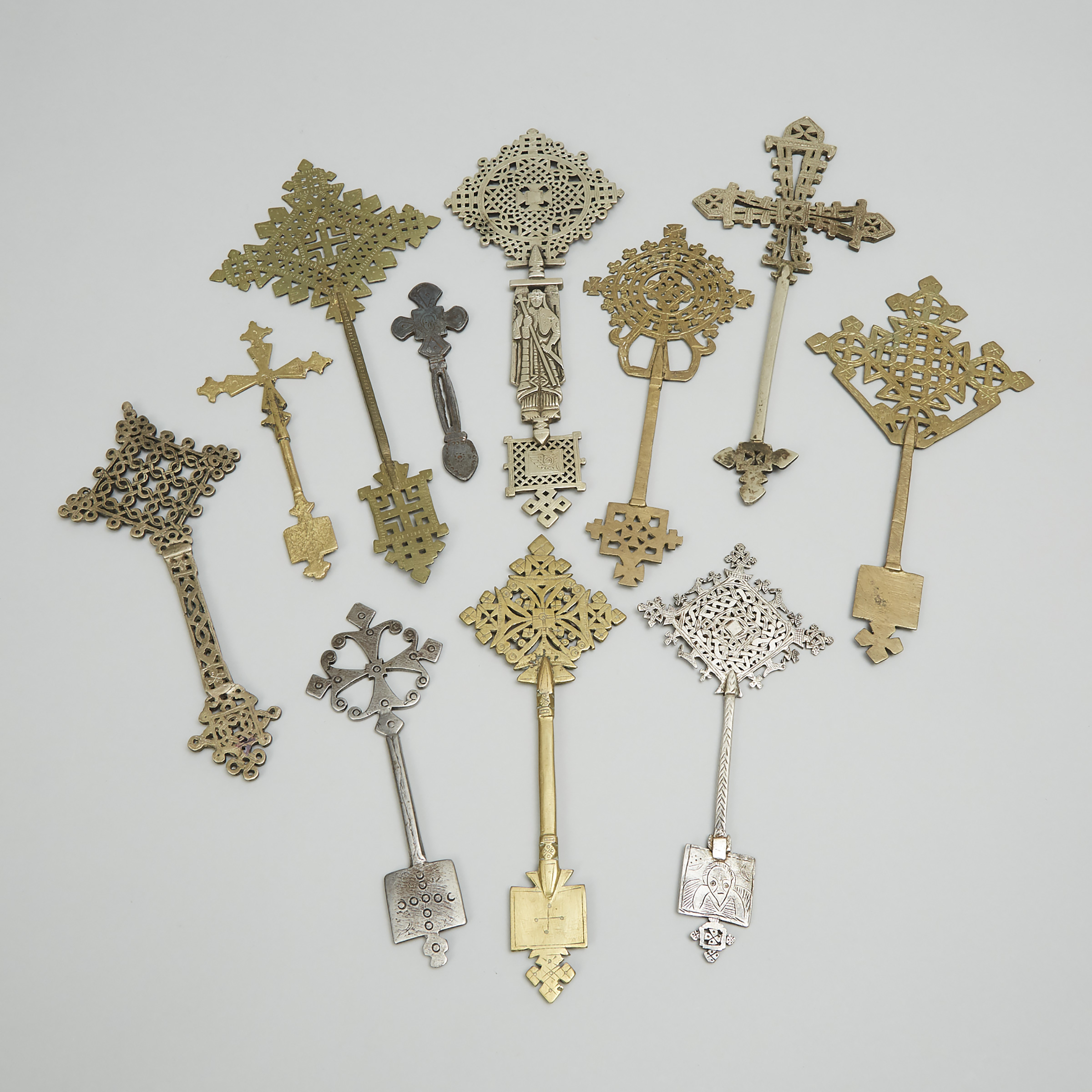 Eleven Abyssinian/Ethiopian Brass and Silvered Brass Coptic Hand Crosses, early-mid 20th century