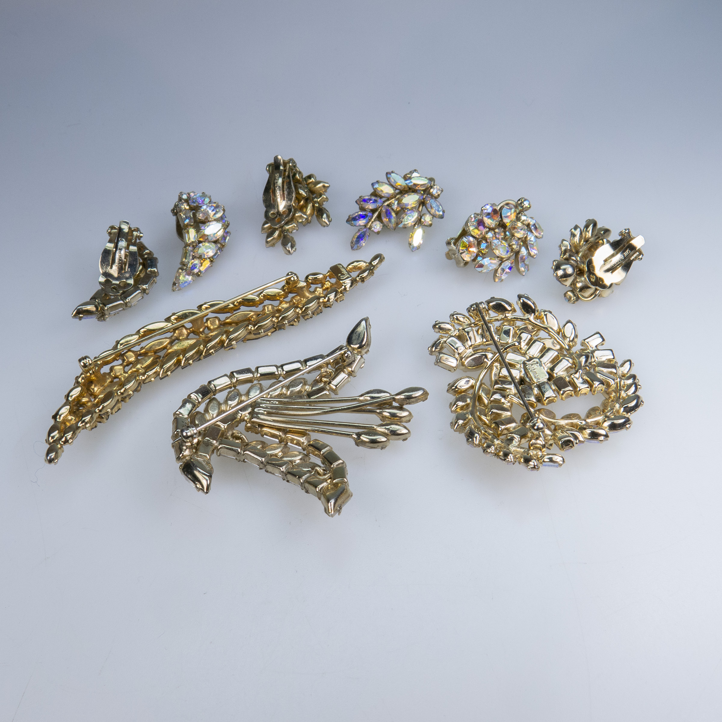 Three Sherman Gold Tone Metal Brooches And Three Pairs Of Clip-Back Earrings
