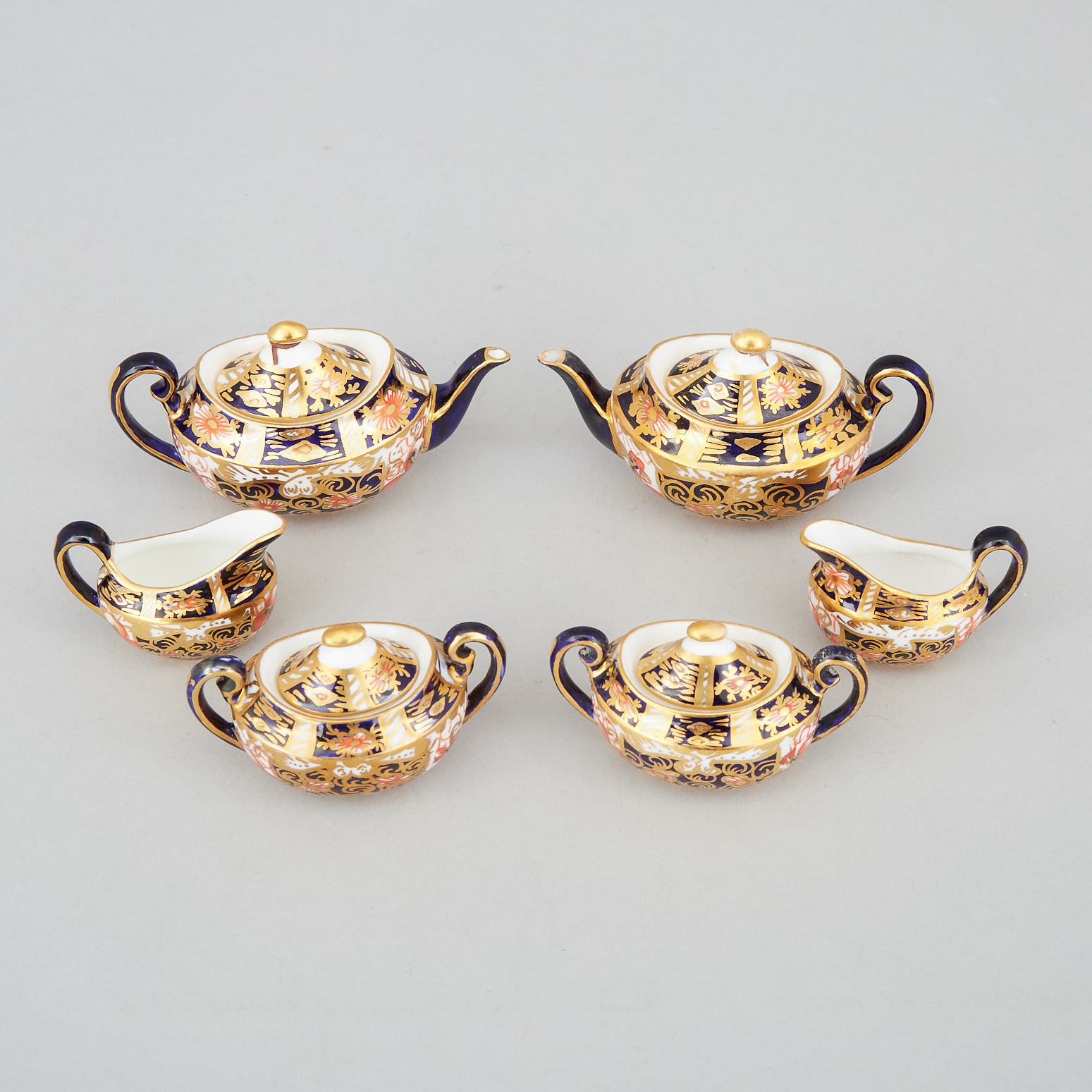 Two Royal Crown Derby 'Imari' (2451) Pattern Miniature Three-Piece Tea Services, 20th century