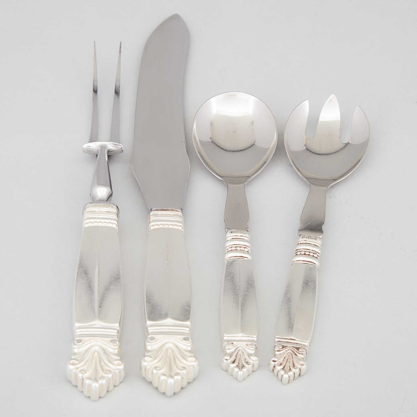 Pair of Danish Silver ‘Acanthus’ Pattern Carving Knife and Fork and a Pair of Salad Servers, Johan Rohde for Georg Jensen, Copenhagen, 20th century