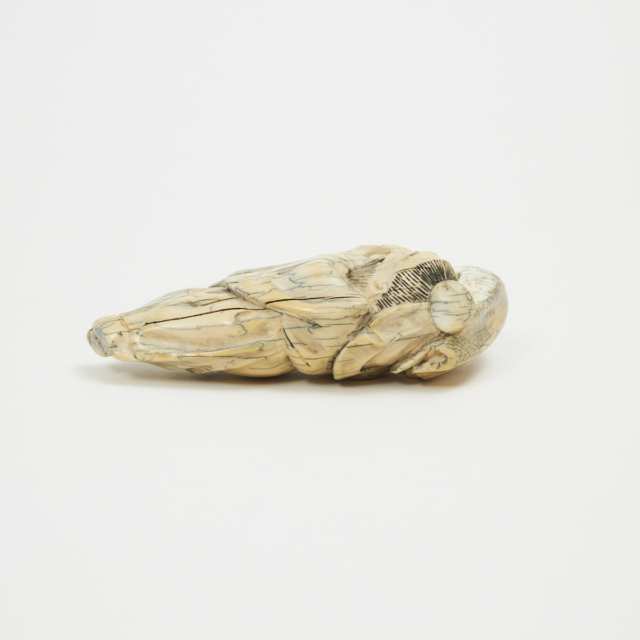 An Ivory Carved Figure of a Reclining Sage