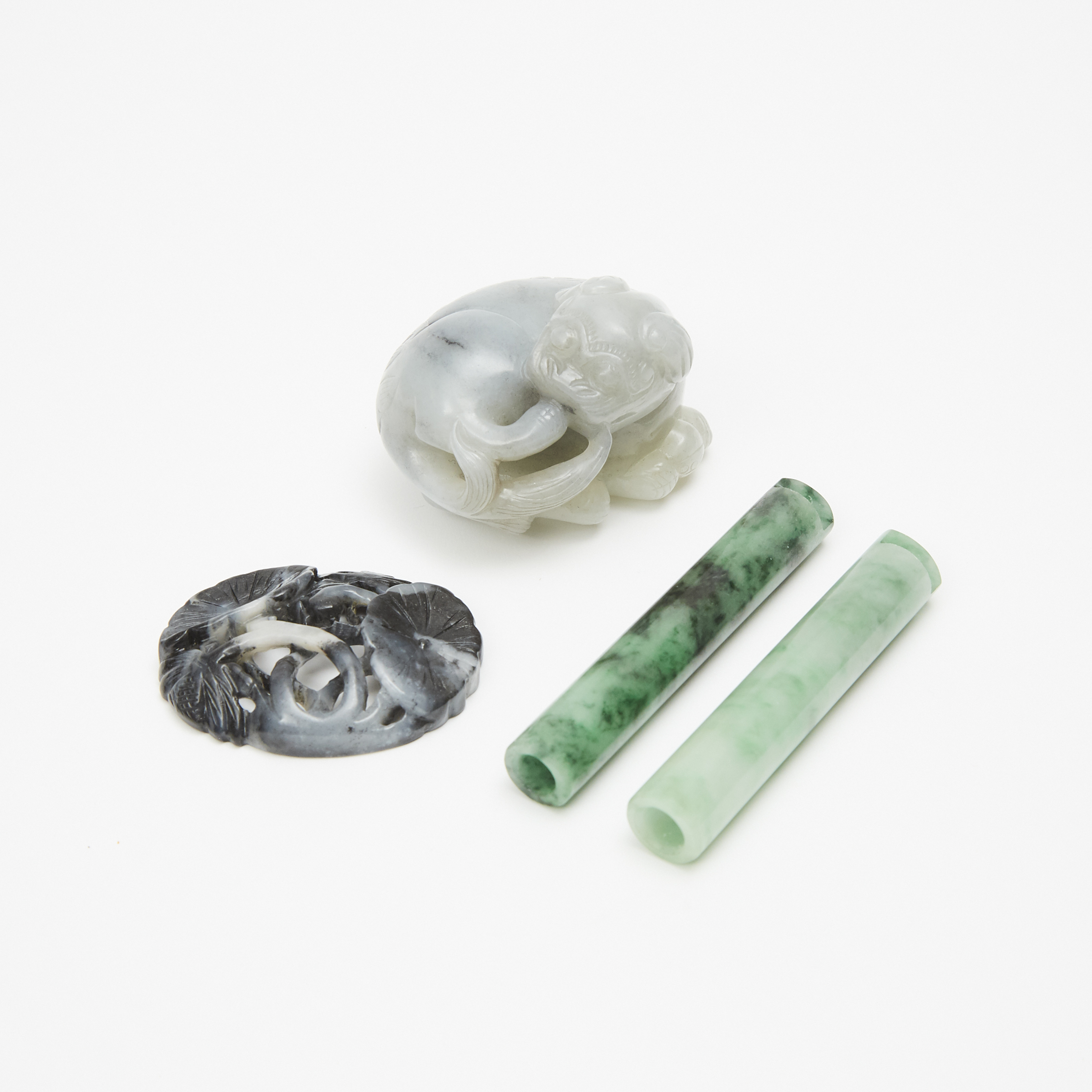 Two Jadeite Quill Tubes, a Greyish-White Jade Carved Fu Dog, and a Black and White Jade Carved 'Lotus' Plaque