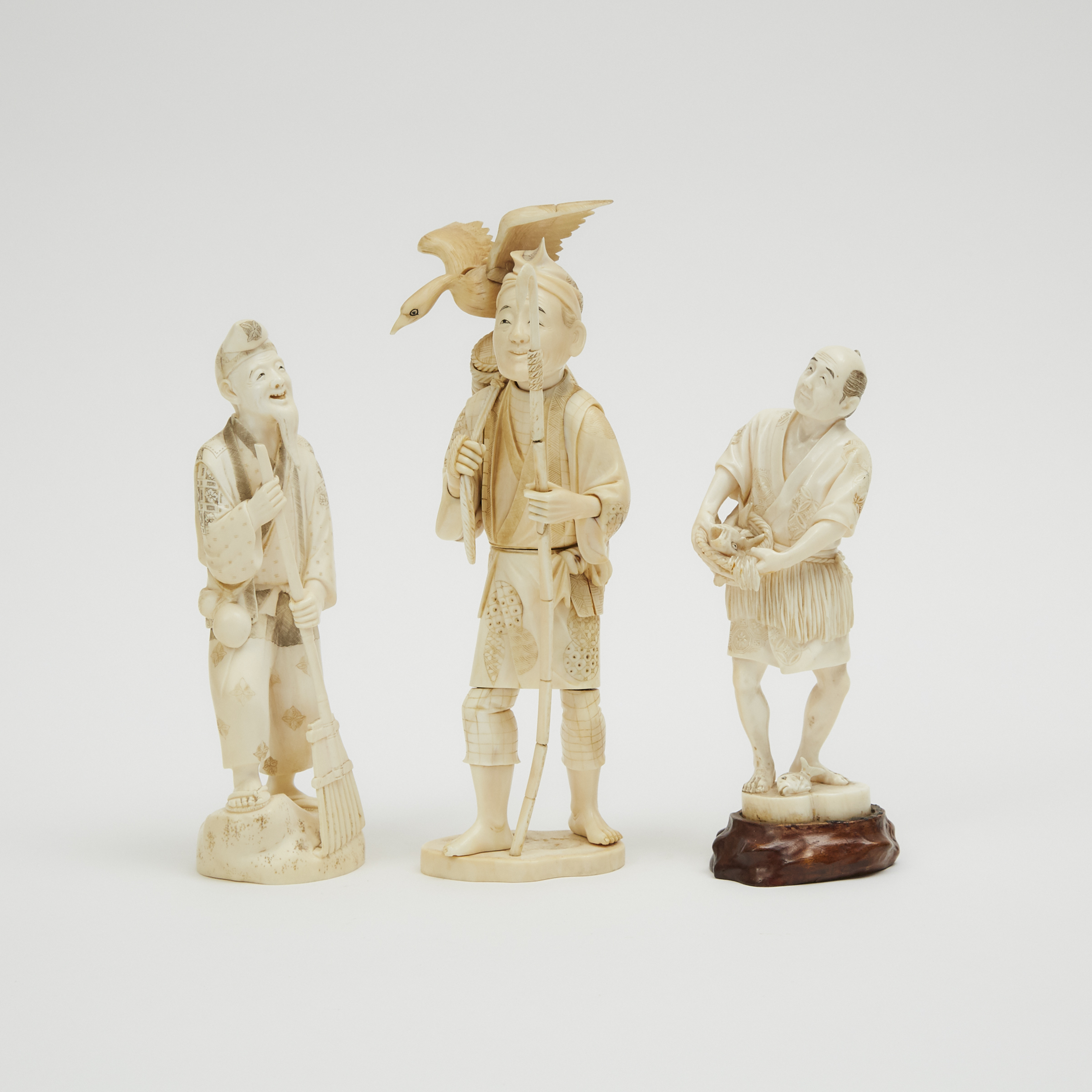 A Group of Three Ivory Okimono of Old Men, Meiji Period