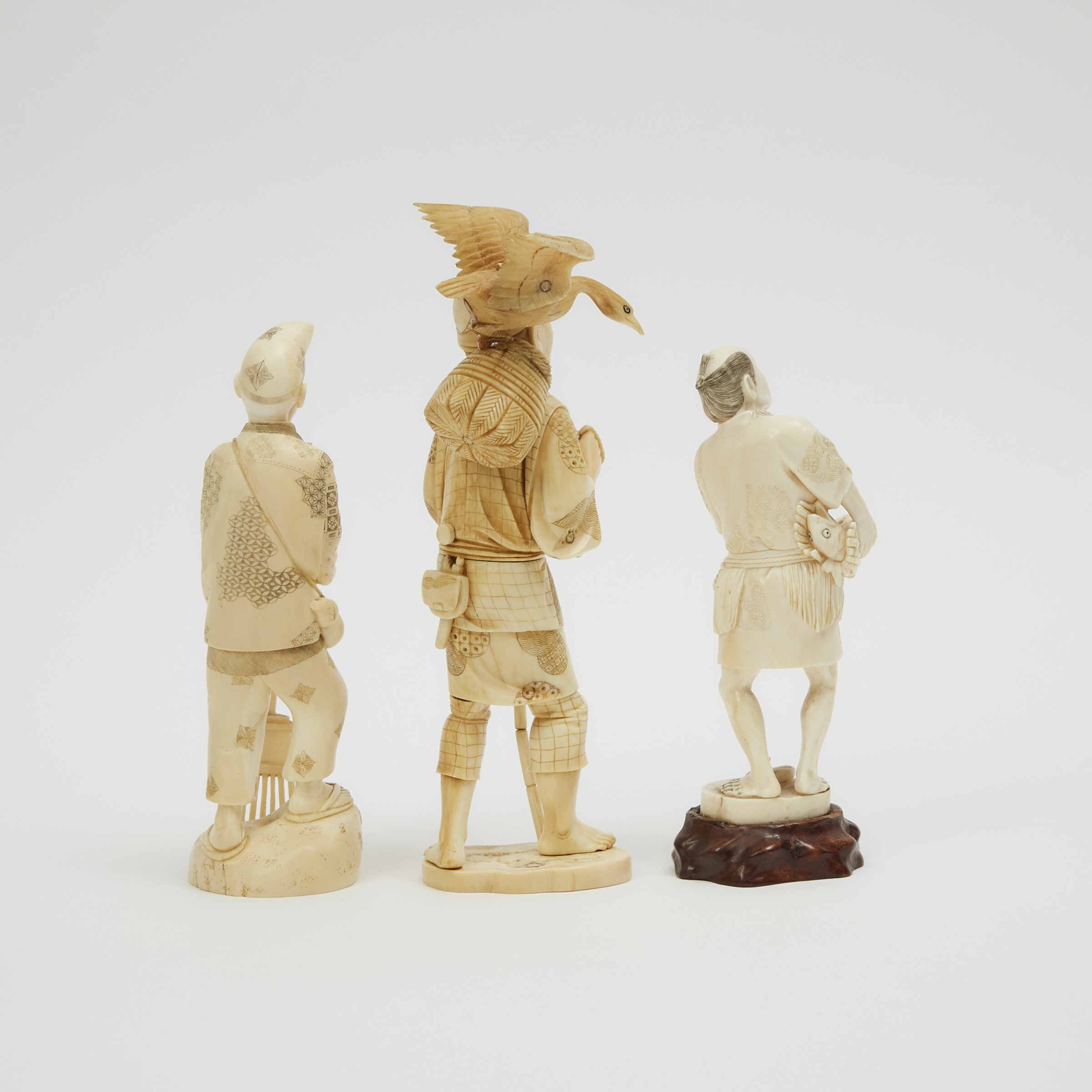 A Group of Three Ivory Okimono of Old Men, Meiji Period