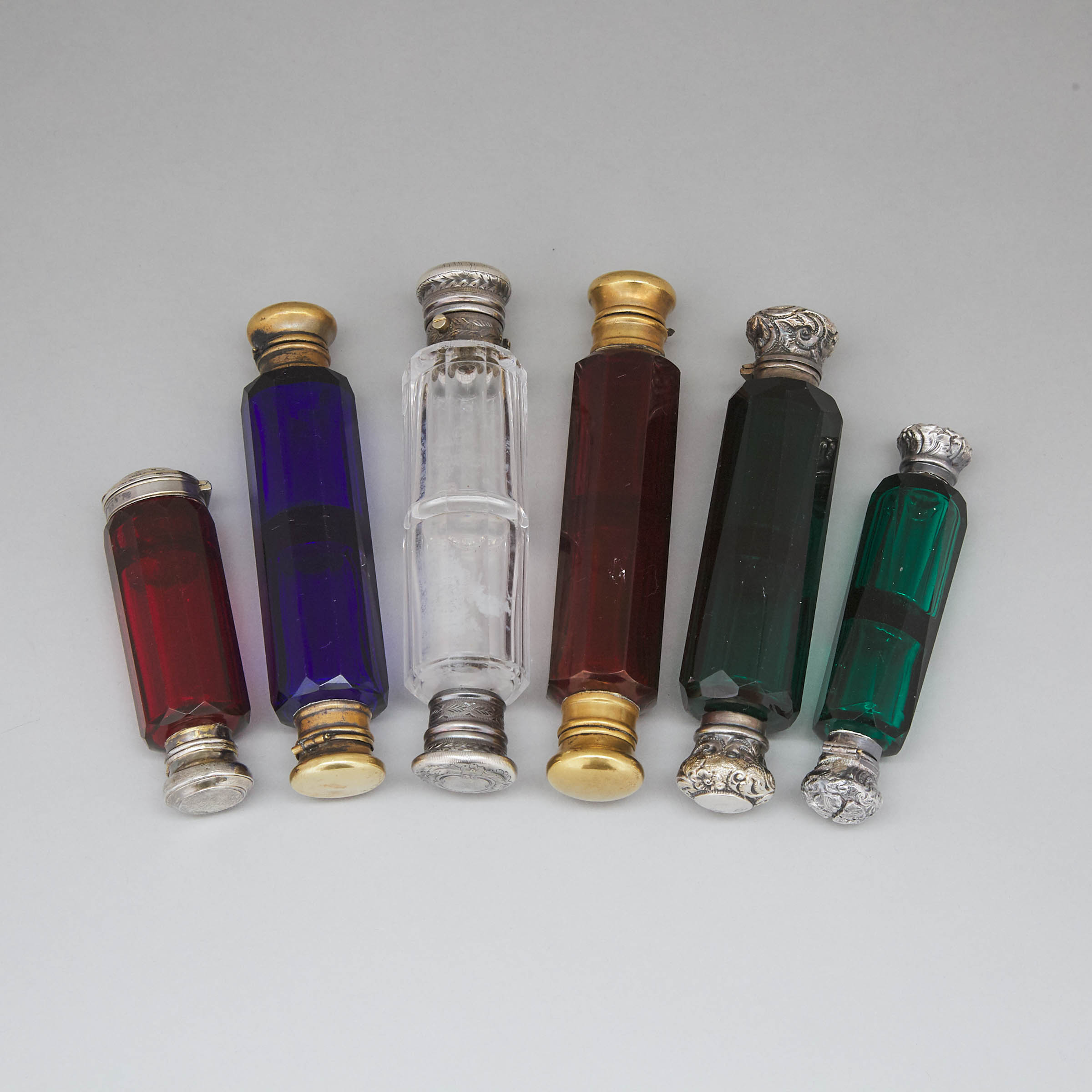 Six Silver and Metal Mounted Red, Green, Blue and Clear Cut Glass Double-Ended Perfume Phials, late 19th century