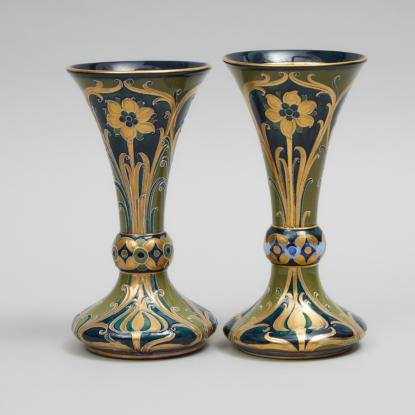 Two Closely Similar Macintyre Moorcroft Green and Gold Florian Trumpet Vases, c.1903