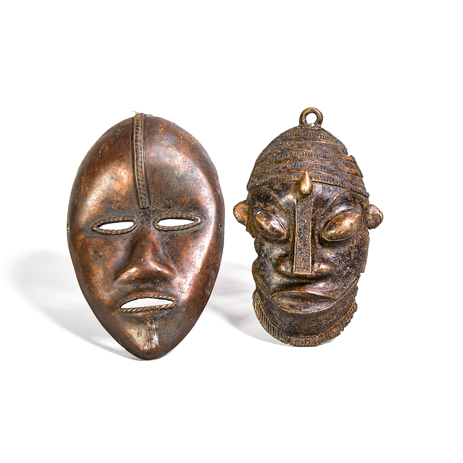 Bamileke Grasslands Bronze Mask, Cameroon, Central Africa together with a bronze Dan mask, Ivory Coast/Liberia, West Africa