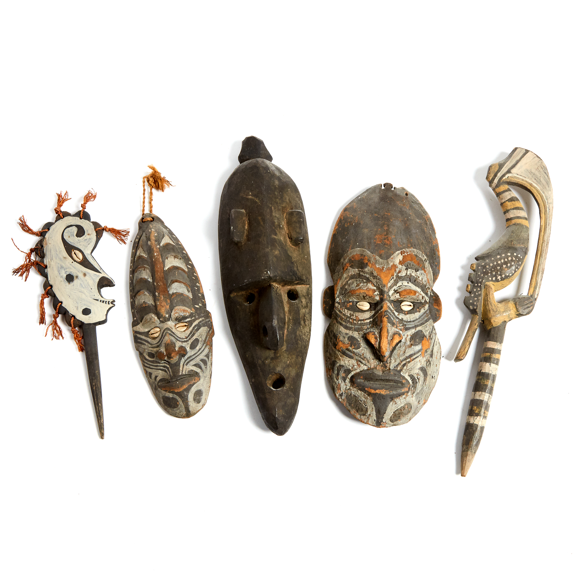 Group of Three Sepik River Masks together with two stakes one depicting a head the other a Hornbill
