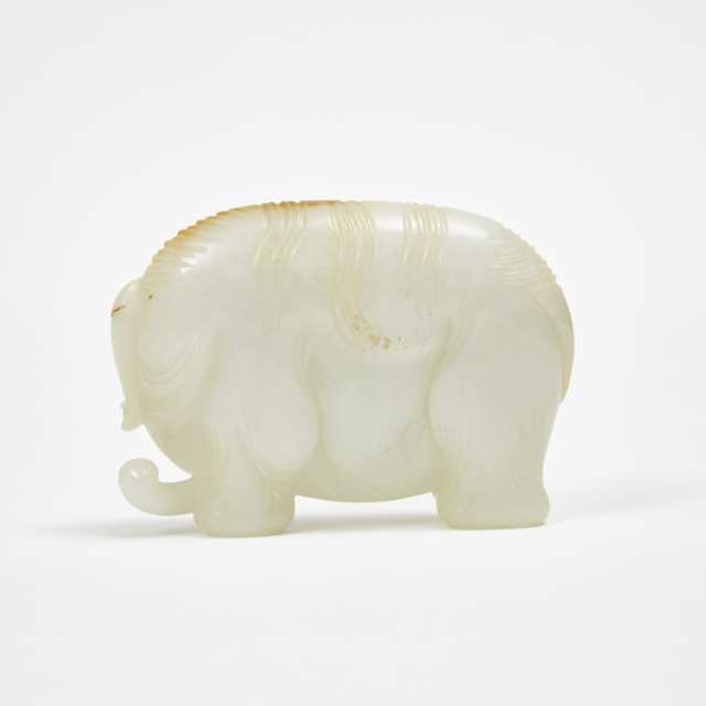A White and Russet Jade Carving of an Elephant