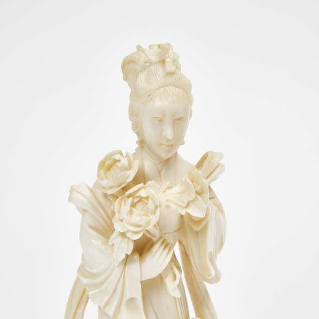 An Ivory or Composite Carved Lady with Flowers