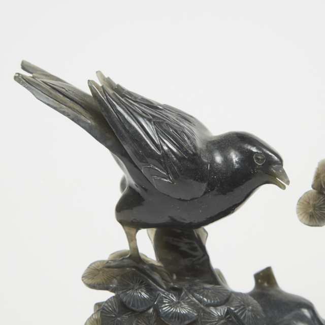 A Dark Hardstone Carved Bird on Pine 