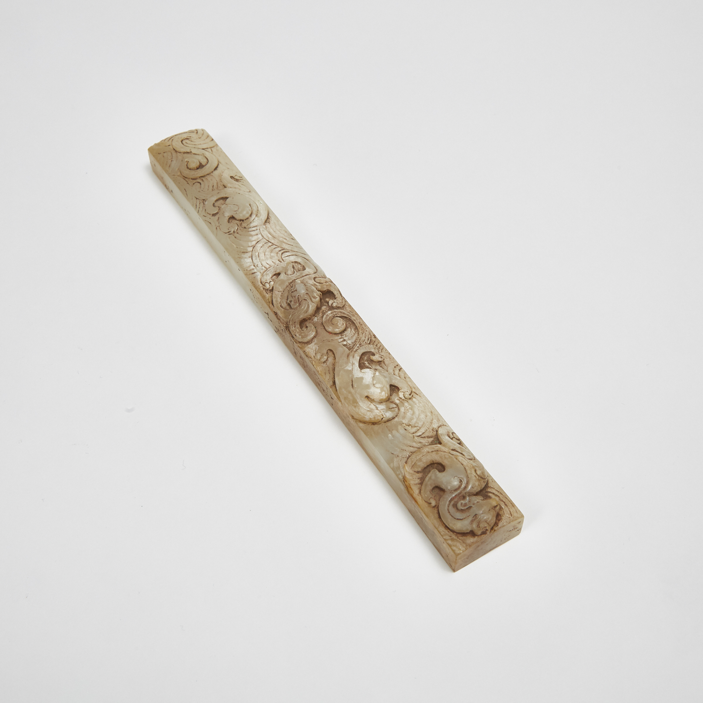 A White and Russet Jade Scroll Weight Carved with Chilong Dragons