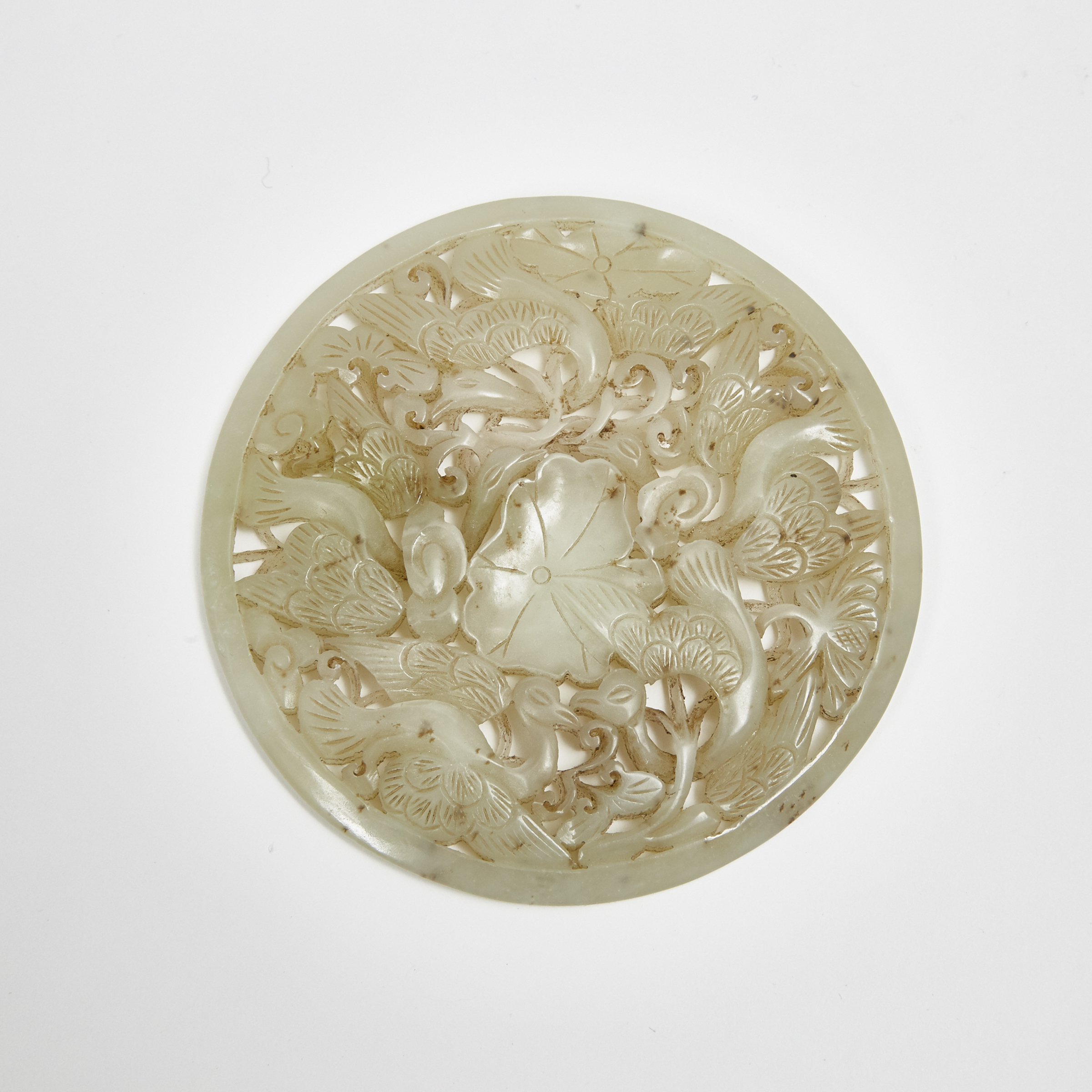 A Reticulated Celadon Jade Roundel with Cranes