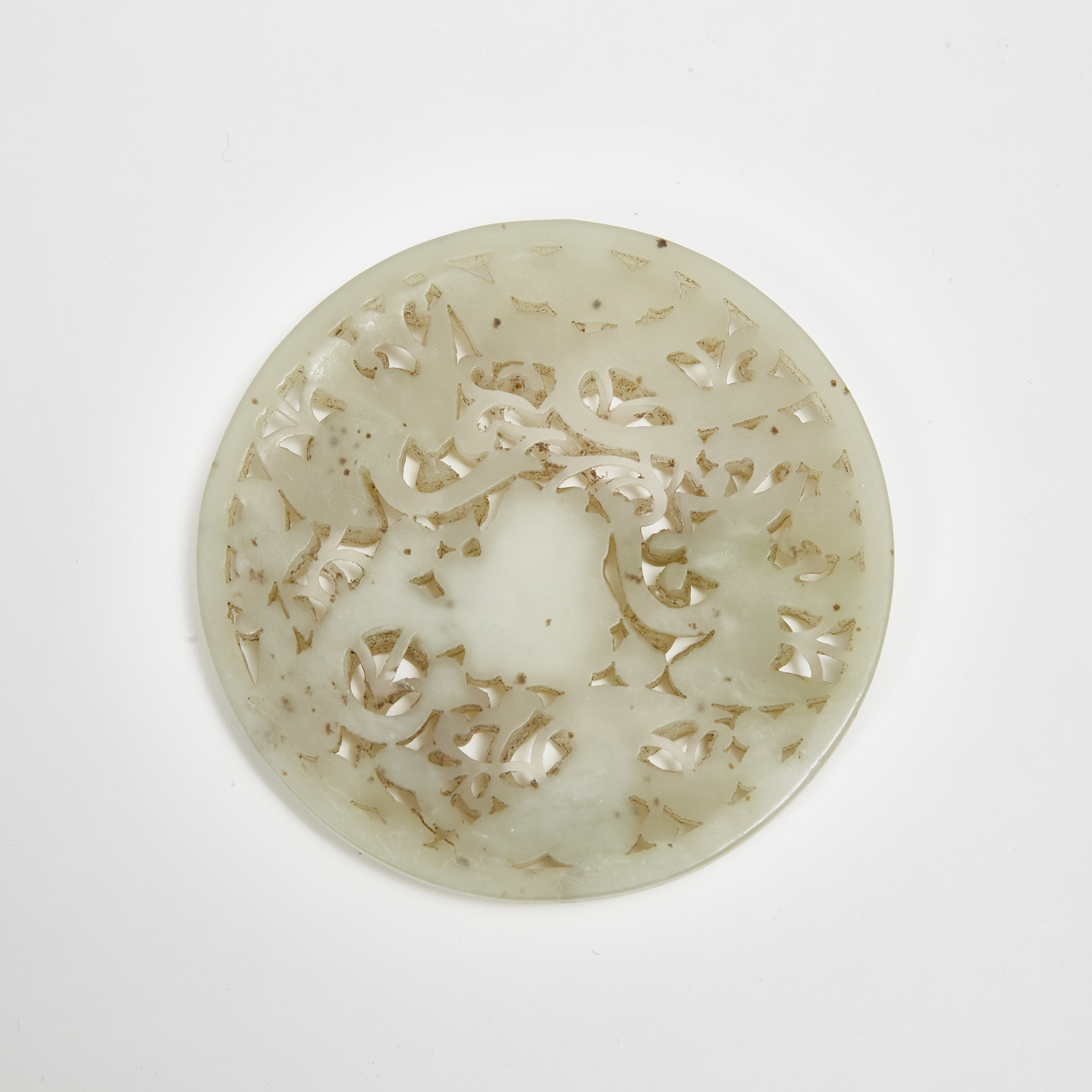 A Reticulated Celadon Jade Roundel with Cranes