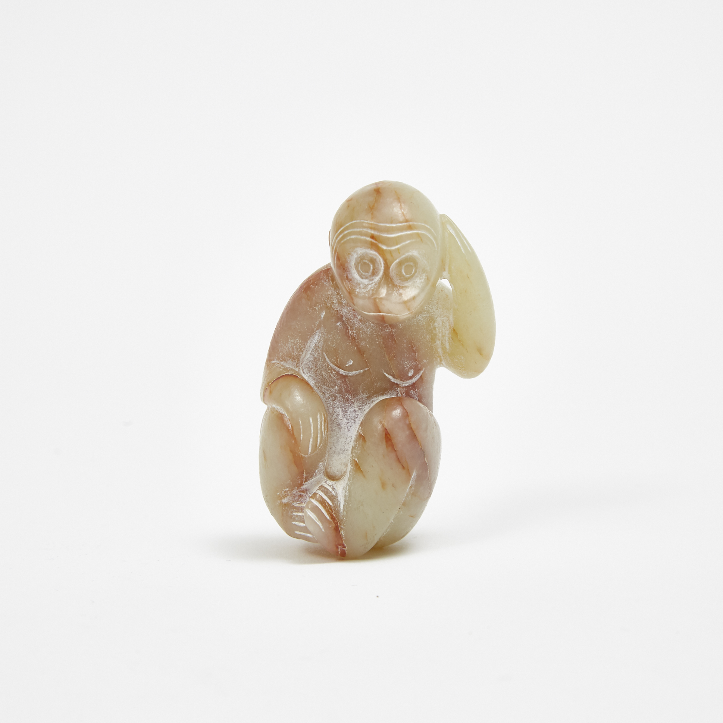 A White and Russet Stone Carving of a Monkey