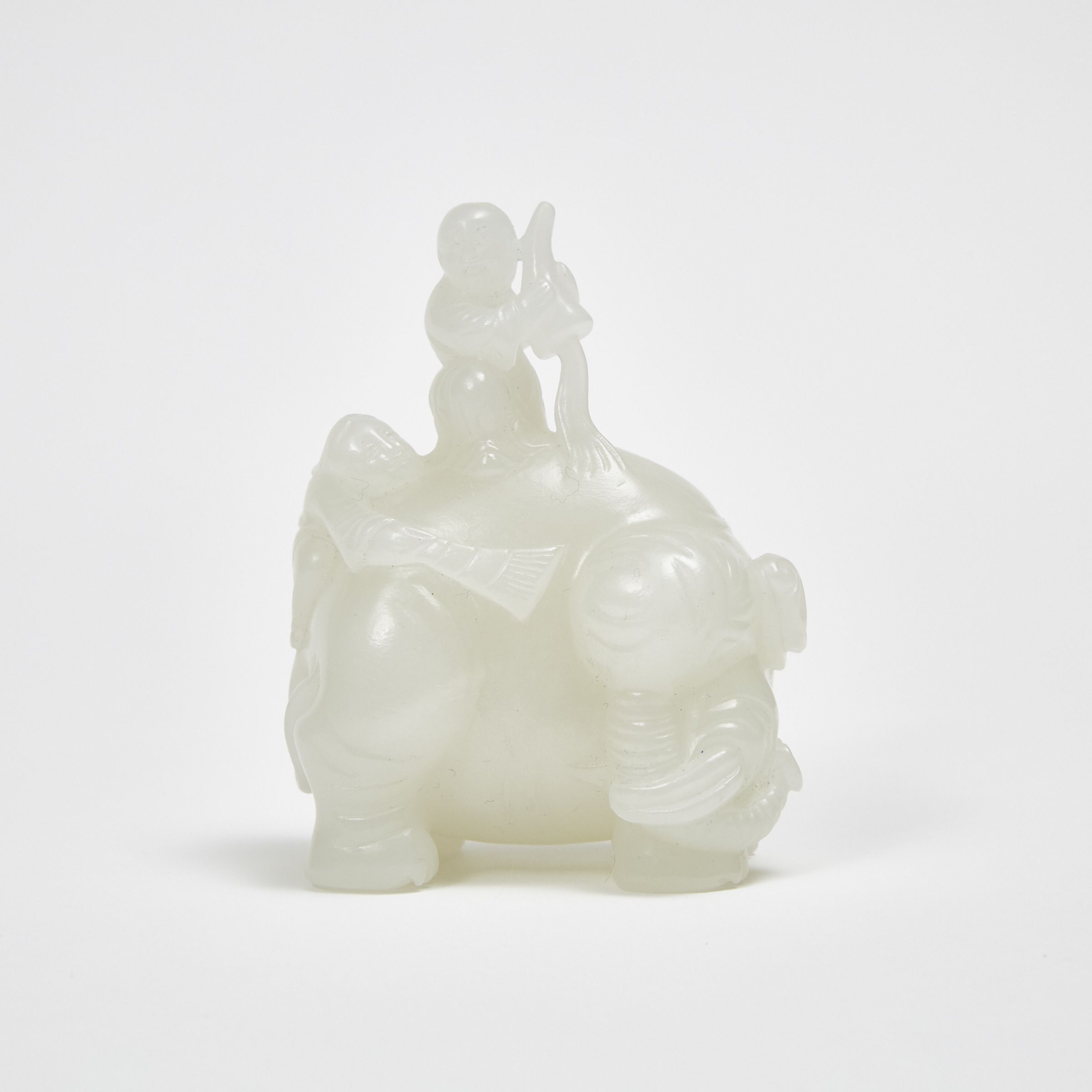 A White Jade Carved 'Cleaning the Elephant' Group