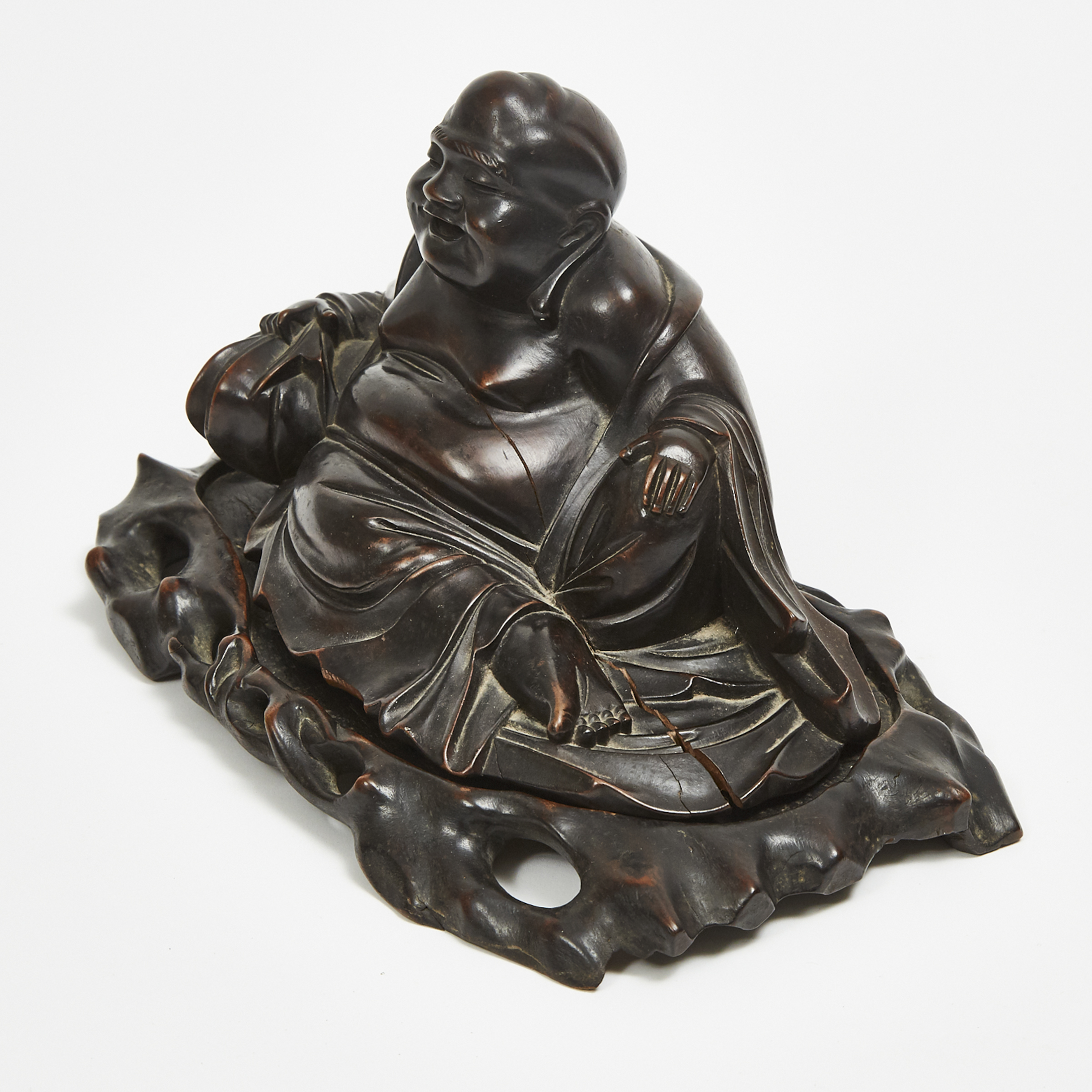 A Hardwood Carved Reclining Laughing Buddha with Stand