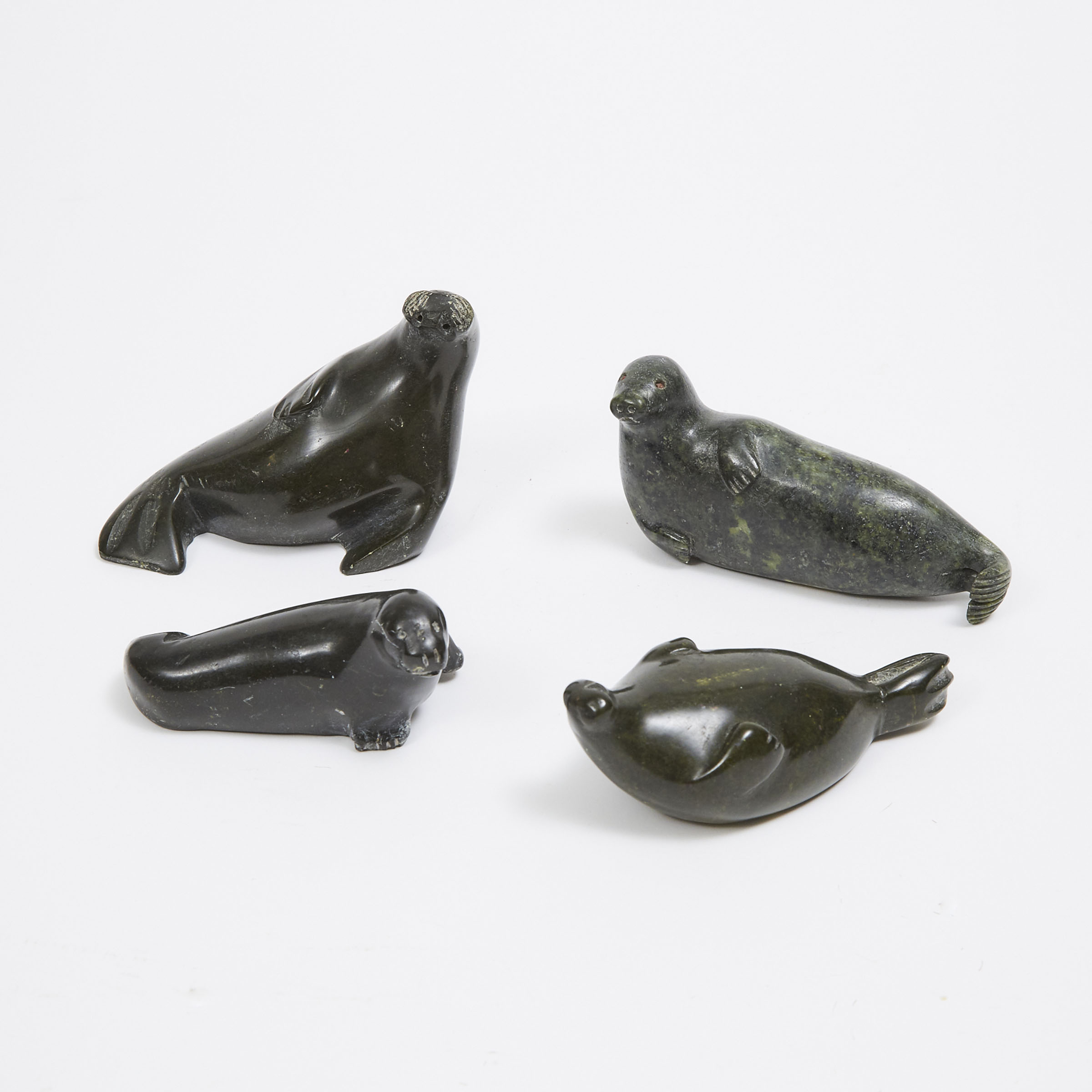 A COLLECTION OF FOUR SEAL SCULPTURES